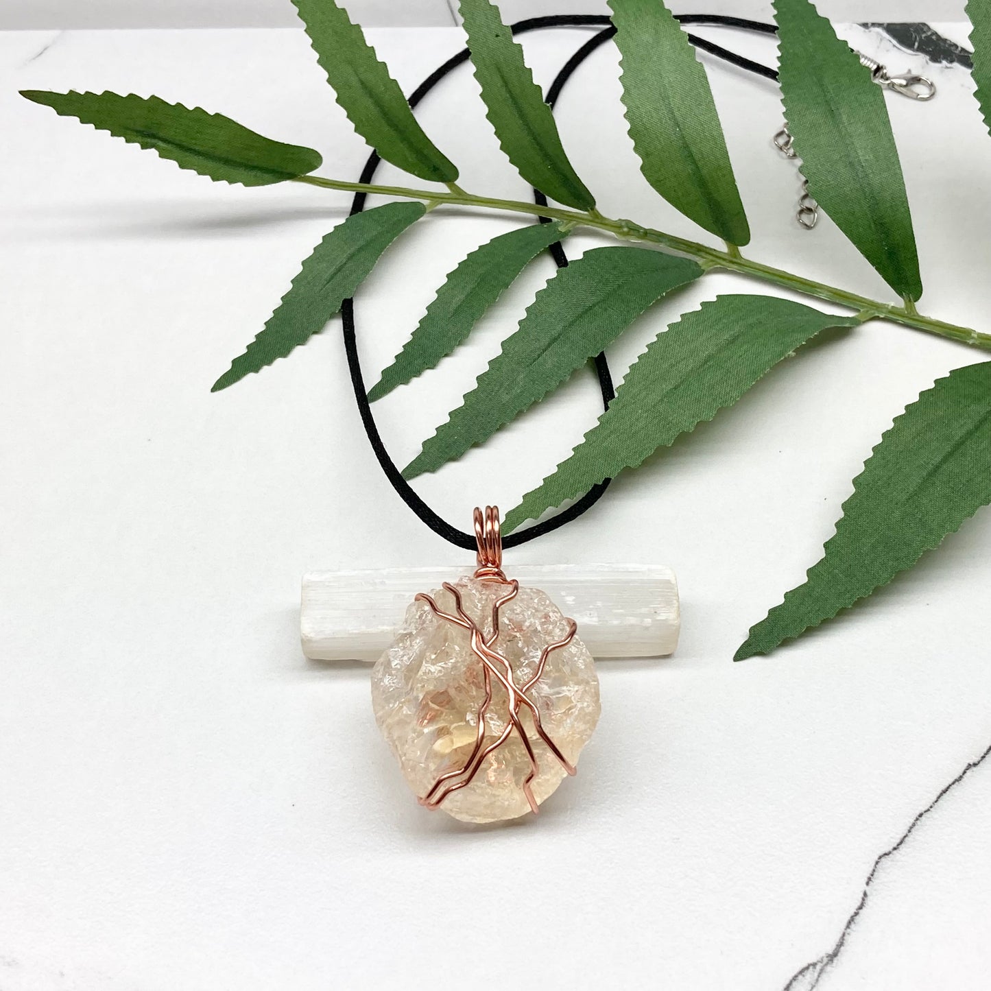 Chunky Citrine necklace. Light yellow crystal wrapped with pure copper wire. hangs on a black chain. 