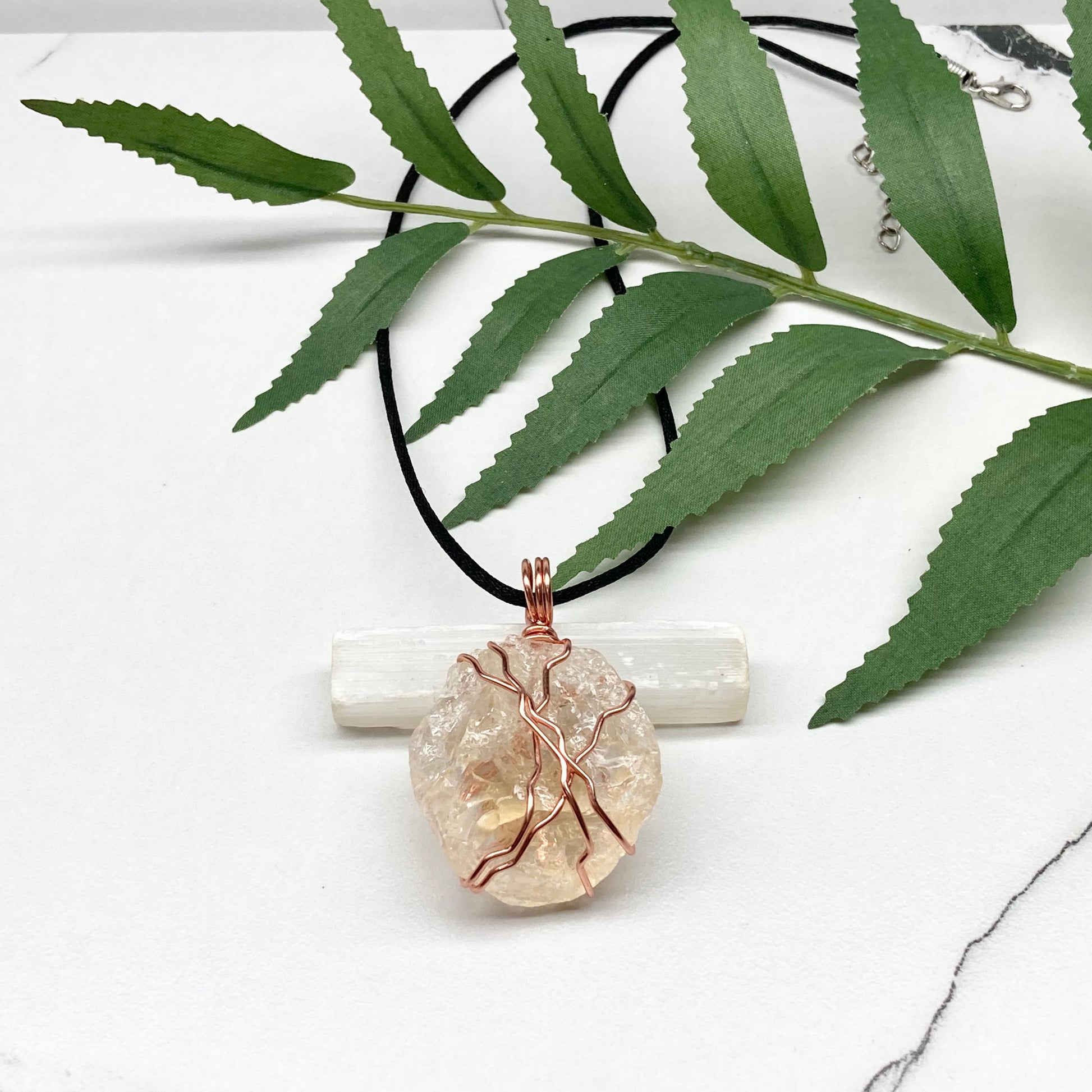 Chunky Citrine necklace. Light yellow crystal wrapped with pure copper wire. hangs on a black chain. 