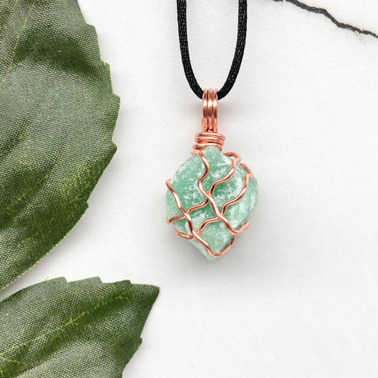 Green Aventurine Necklace. Raw Green Aventurine crystal wrapped with copper wire. Comes on a black chain.