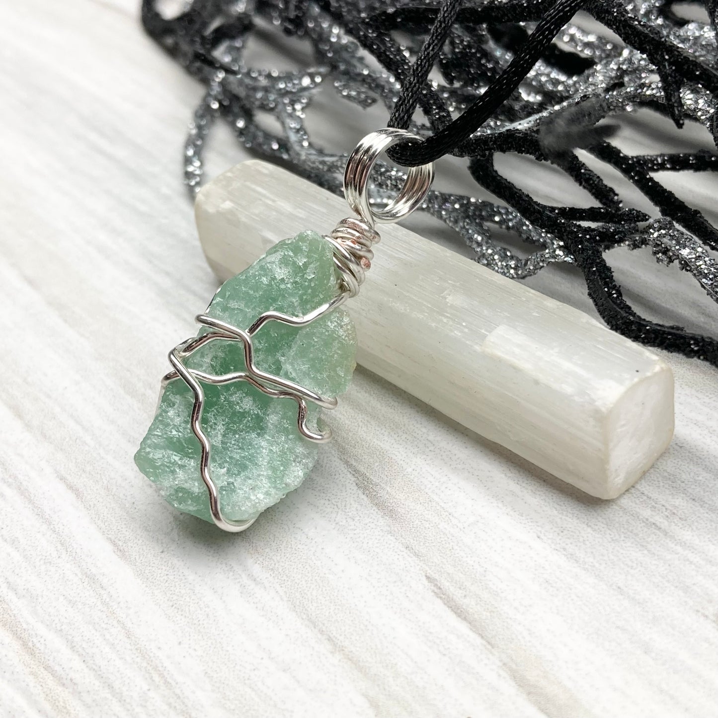 Green Aventurine necklace. Raw Green Aventurine stone wrapped with silver colored copper wire. Comes on a black chain. Wire wrapped green crystal pendant. 