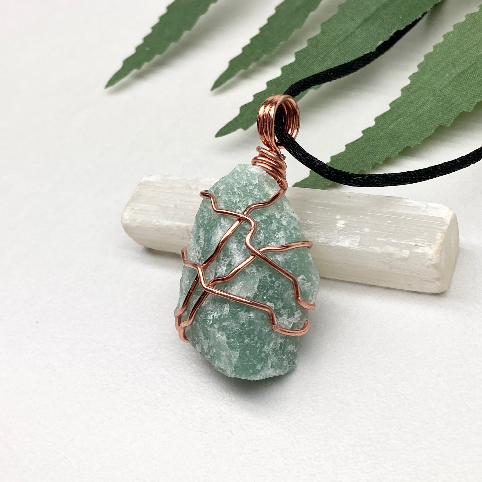 Green Aventurine necklace. Green stone wrapped with copper wire. Comes on a black chain. Hanfcrafted metaphysical jewelry.