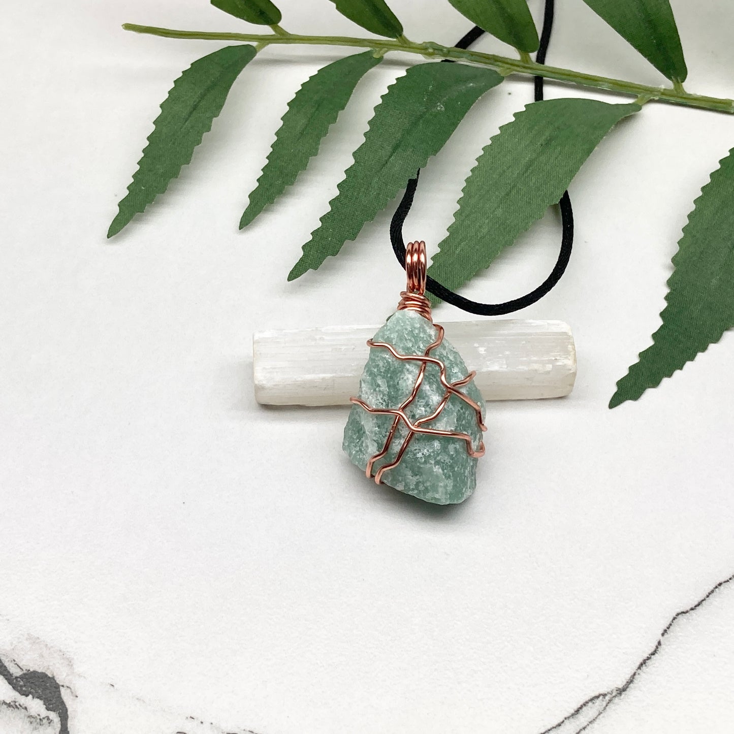 Green Aventurine necklace. Green stone wrapped with copper wire. Comes on a black chain. Hanfcrafted metaphysical jewelry.