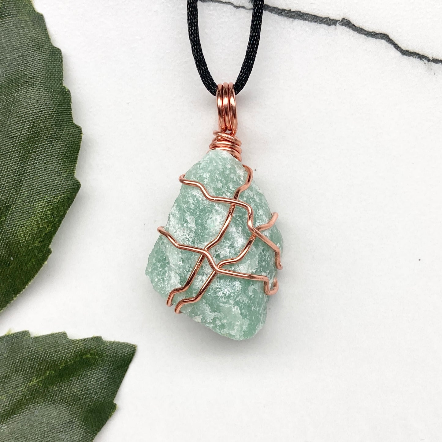 Green Aventurine necklace. Green stone wrapped with copper wire. Comes on a black chain. Hanfcrafted metaphysical jewelry.