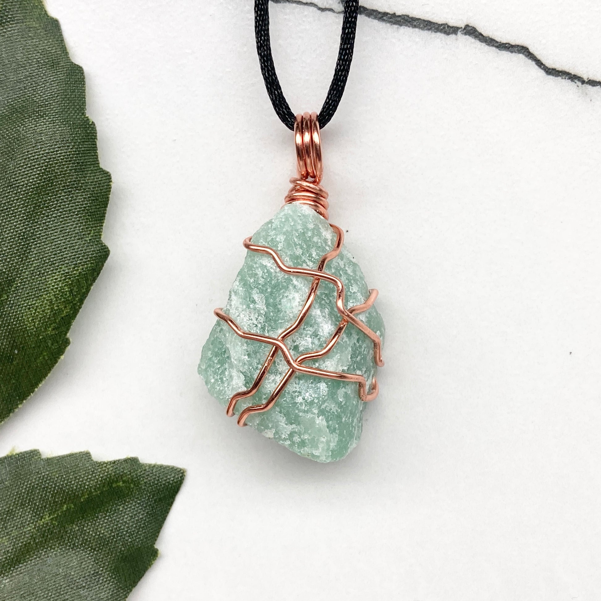 Green Aventurine necklace. Green stone wrapped with copper wire. Comes on a black chain. Hanfcrafted metaphysical jewelry.