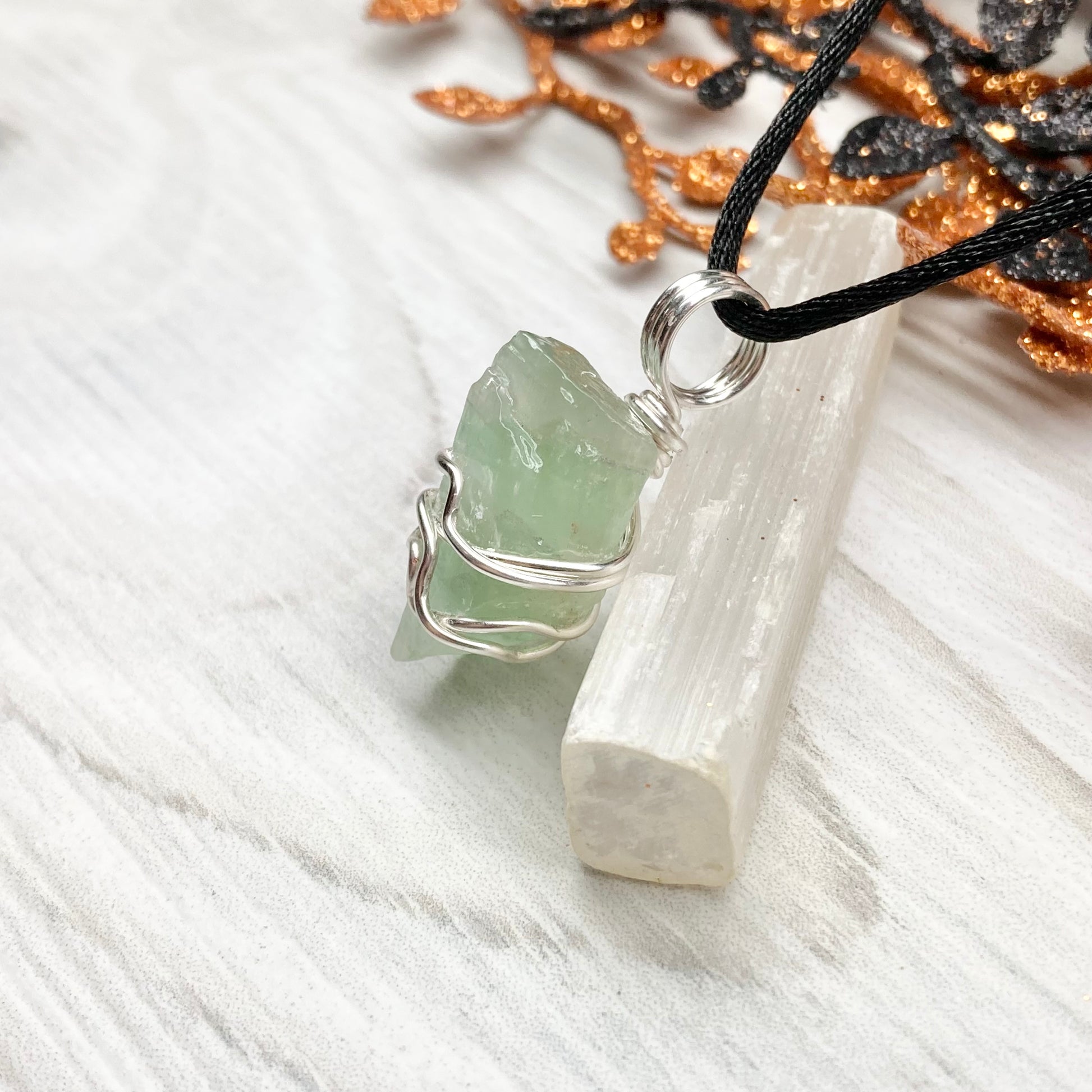 Green Calcite Necklace. Green Calcite wrapped with silver colored copper wire. Comes on a black chain. Wire wrapped green crystal pendant. 