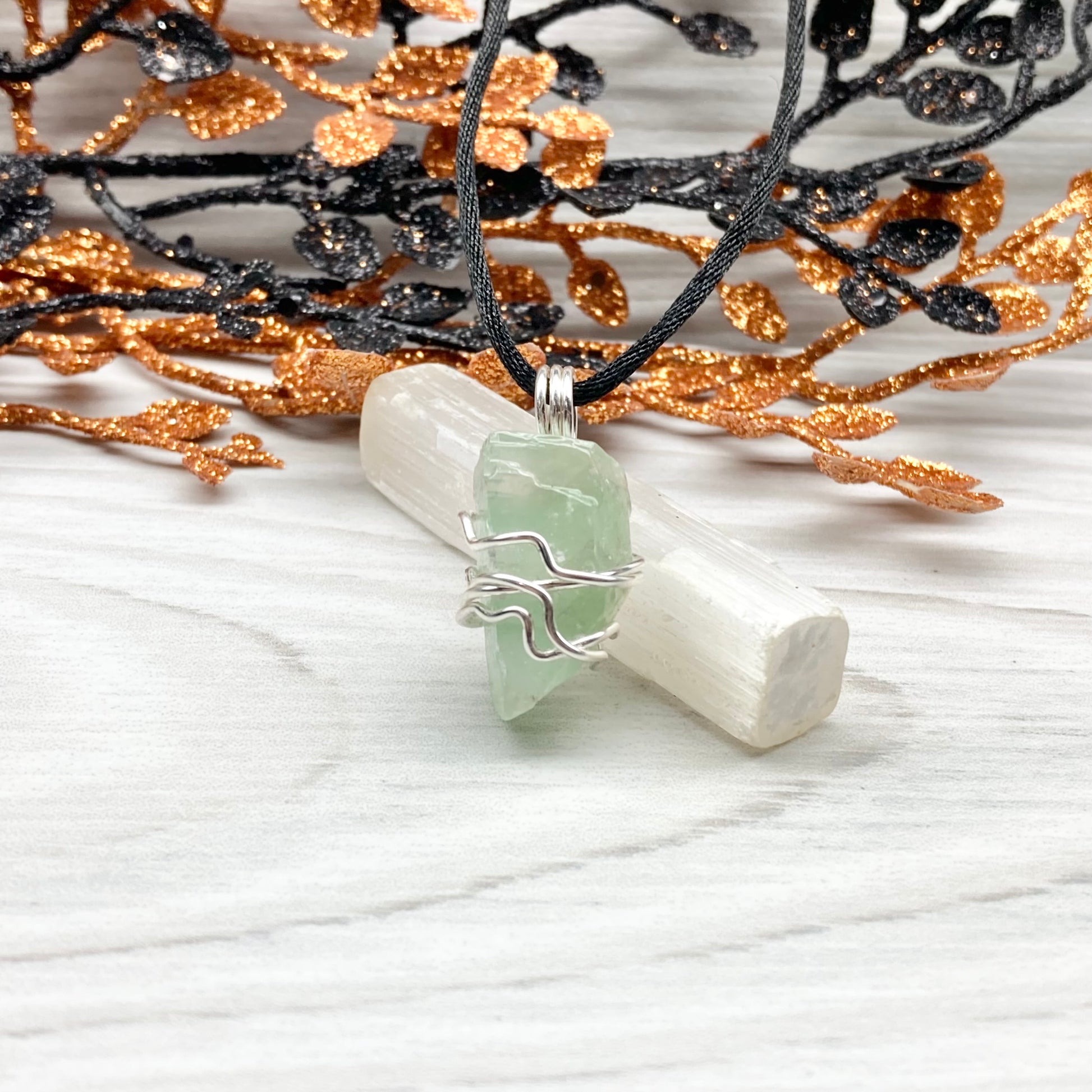 Green Calcite Necklace. Green Calcite wrapped with silver colored copper wire. Comes on a black chain. Wire wrapped green crystal pendant. 