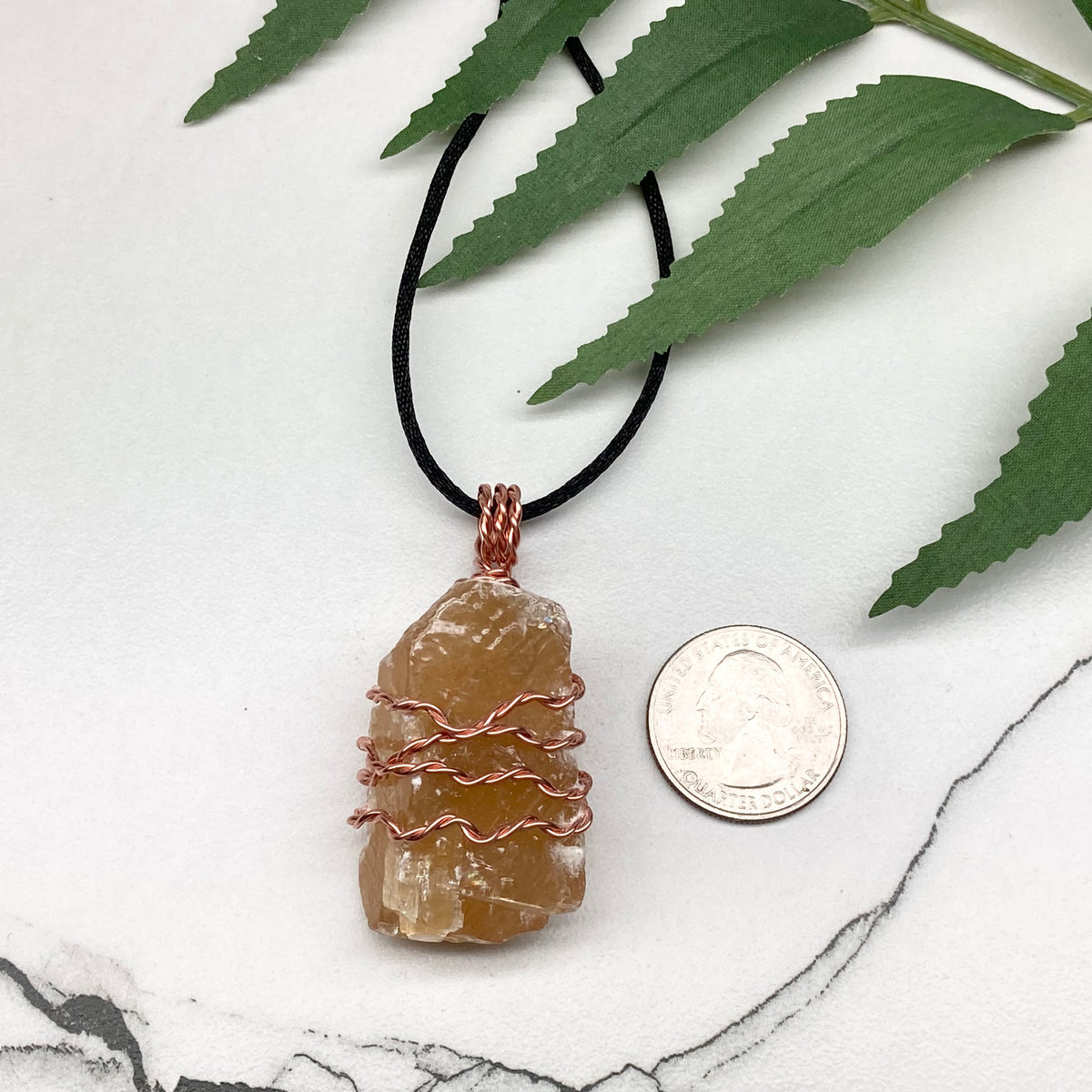 Honey Calcite necklace. Raw chunky yellow stone wrapped with pure copper wire. Hangs on a black chain. Metaphysical handmade jewelry.
