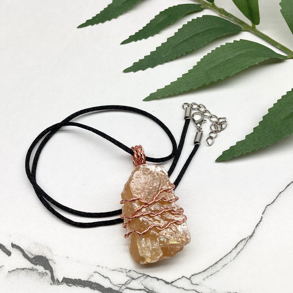 Honey Calcite necklace. Raw chunky yellow stone wrapped with pure copper wire. Hangs on a black chain. Metaphysical handmade jewelry.