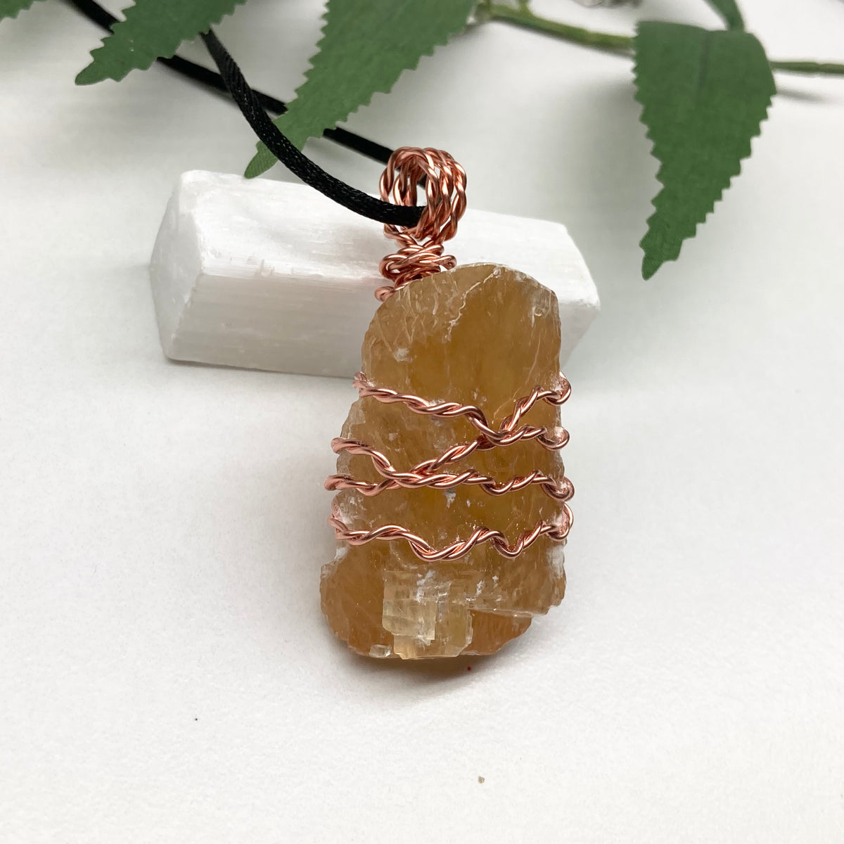 Honey Calcite necklace. Raw chunky yellow stone wrapped with pure copper wire. Hangs on a black chain. Metaphysical handmade jewelry.
