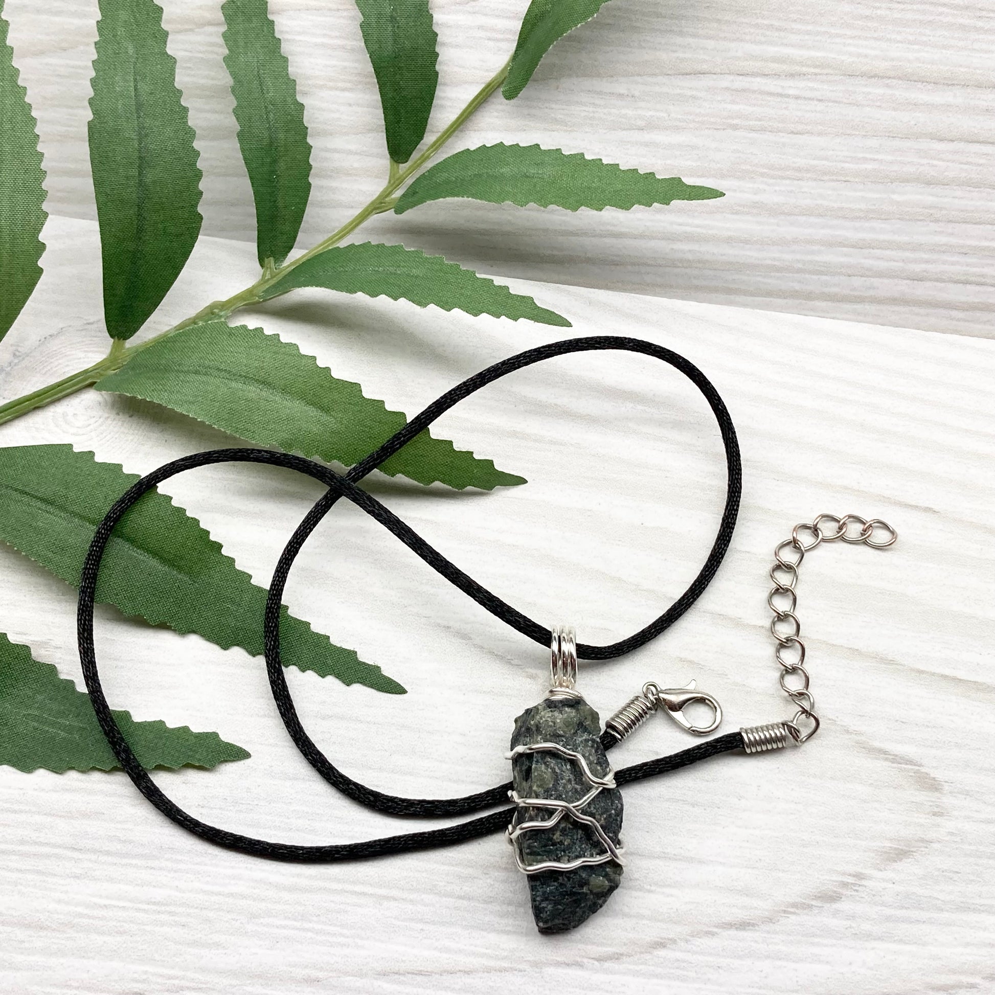 Kambaba Jasper necklace. Raw Kambaba Jasper stone wrapped with silver colored copper wire. Hangs on a black satin silk chain. Wire wrapped green and black crystal  copper pendant. Handcrafted metaphysical jewelry.