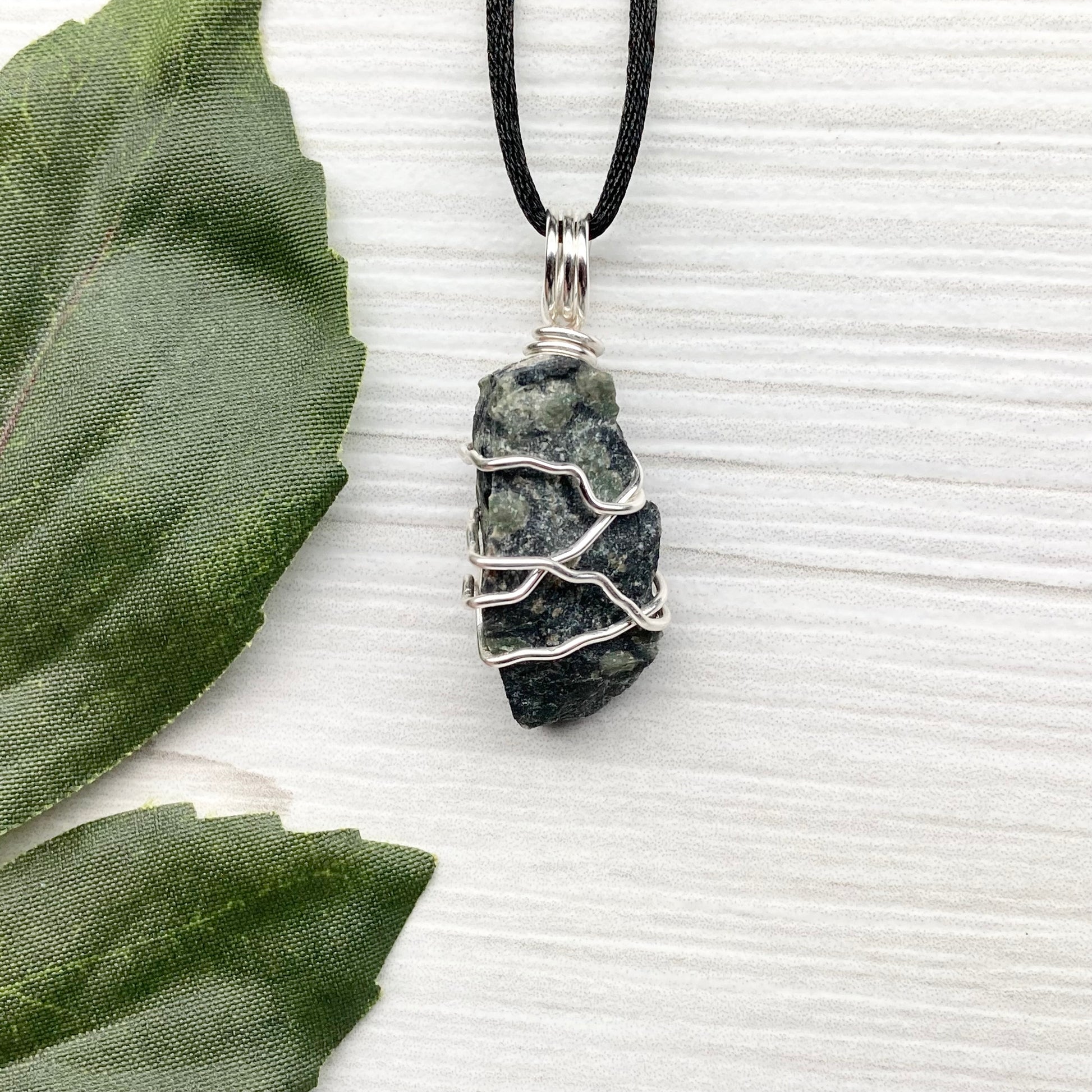 Kambaba Jasper necklace. Raw Kambaba Jasper stone wrapped with silver colored copper wire. Hangs on a black satin silk chain. Wire wrapped green and black crystal  copper pendant. Handcrafted metaphysical jewelry.