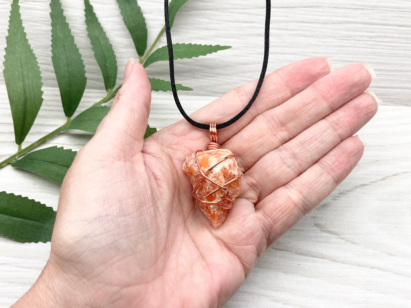 Orange Calcite Necklace. Raw Orange Calcite Crystal Wrapped With Copper Wire That Is Tarnish Resistant. Comes On A Black Necklace. Gemini Zodiac Stone Pendant. Handmade In Tennessee. Pagan Spiritual Jewelry.