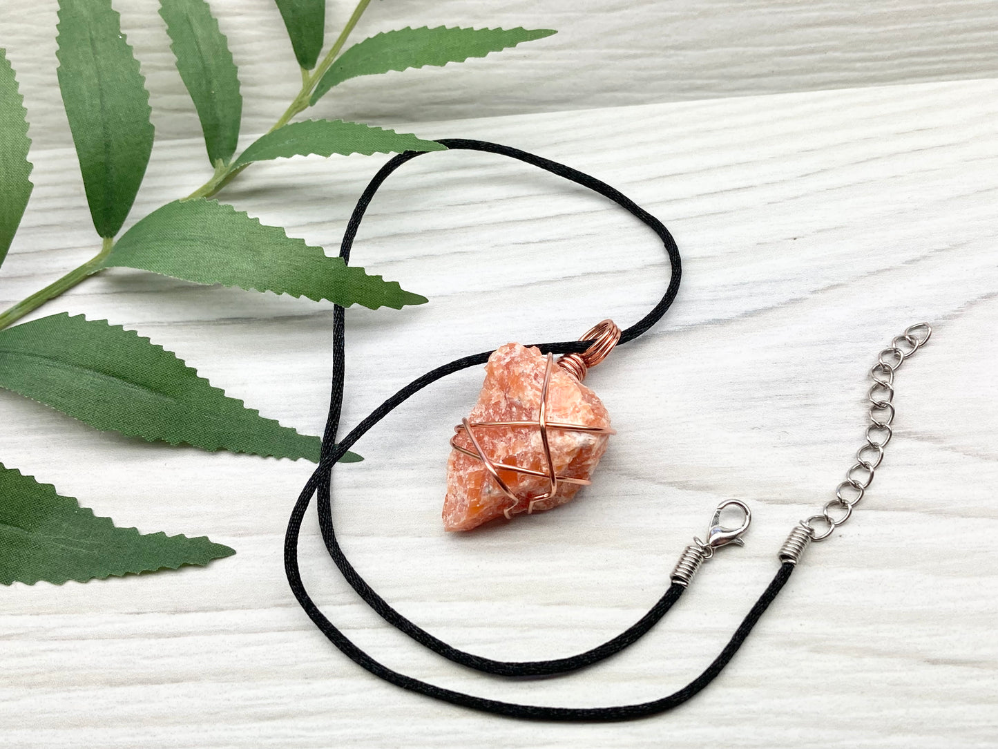 Orange Calcite Necklace. Raw Orange Calcite Crystal Wrapped With Copper Wire That Is Tarnish Resistant. Comes On A Black Necklace. Gemini Zodiac Stone Pendant. Handmade In Tennessee. Pagan Spiritual Jewelry.