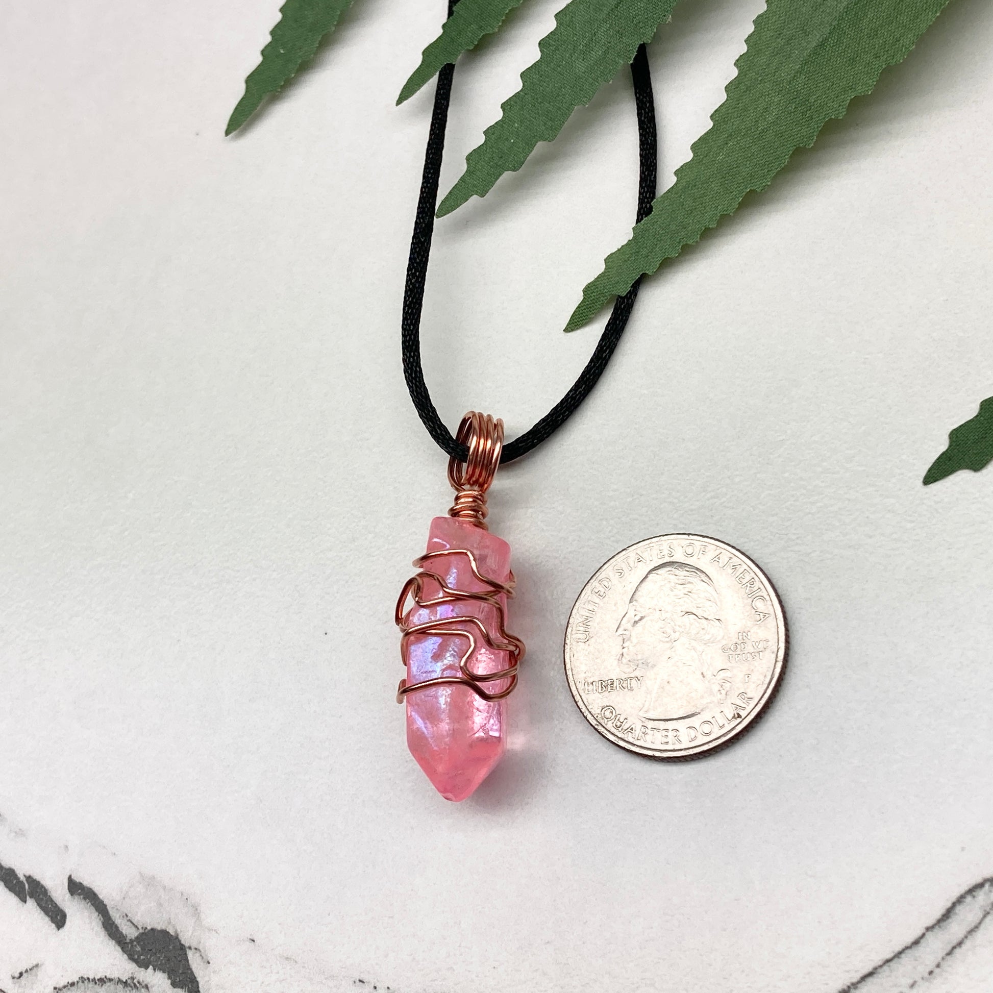Pink Aura Quartz Necklace. Pink Aura Quartz crystal with iridescent shimmer, wrapped in pure copper wire. Hangs on a black chain. 