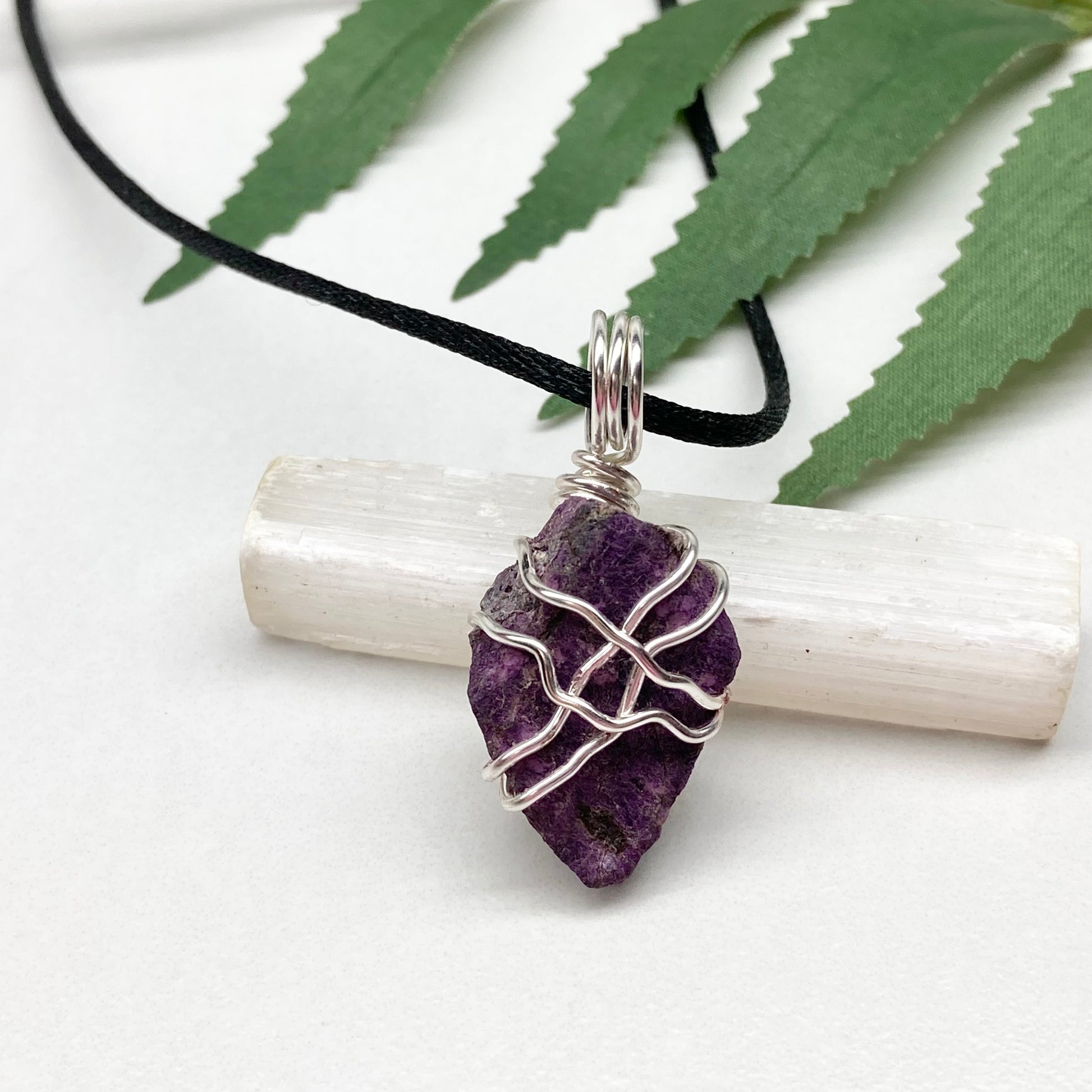 Purpurite necklace. Raw purple Purpurite stone wrapped with silver colored copper wire. Hangs on a black chain. Raw real crystal pendant.