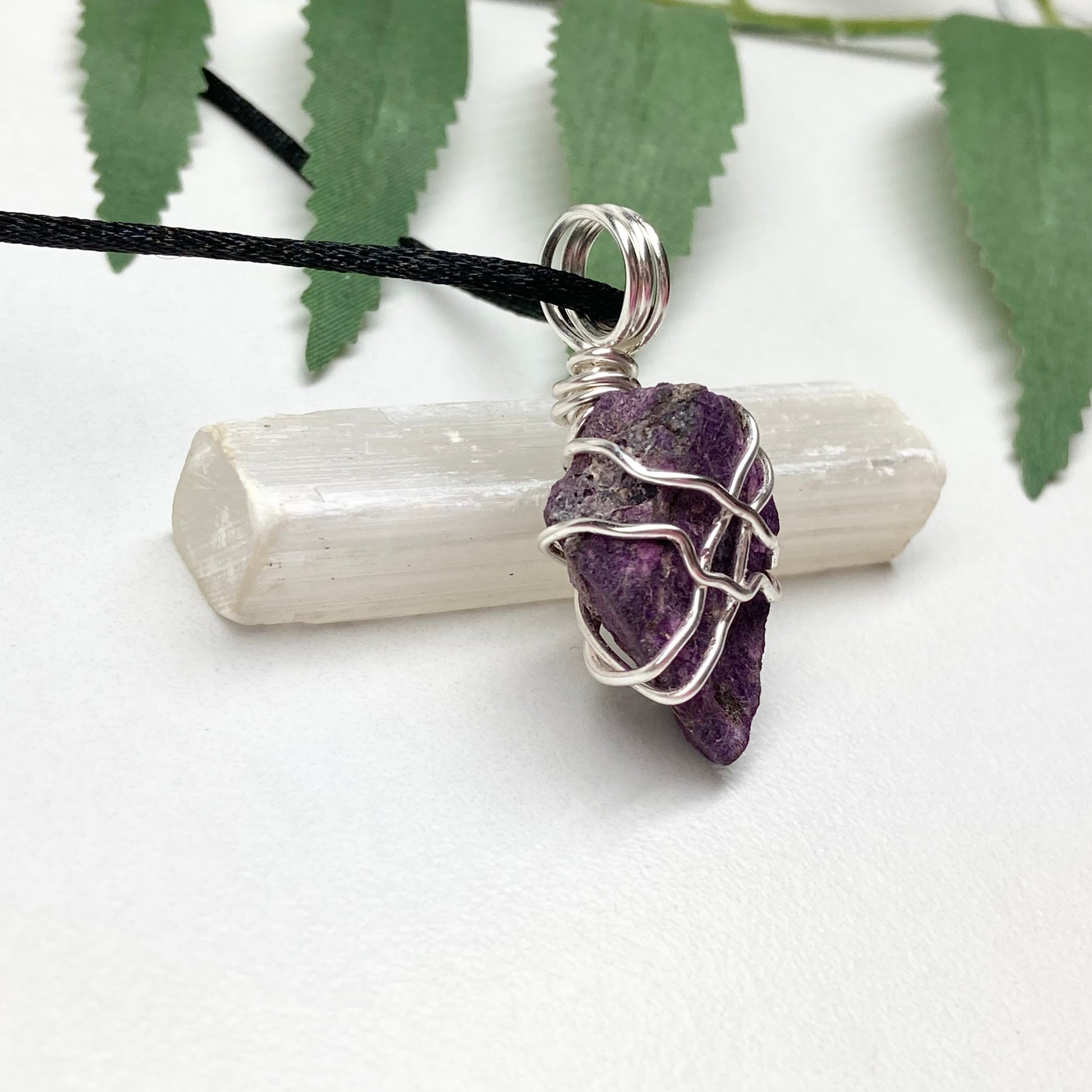 Purpurite necklace. Raw purple Purpurite stone wrapped with silver colored copper wire. Hangs on a black chain. Raw real crystal pendant.