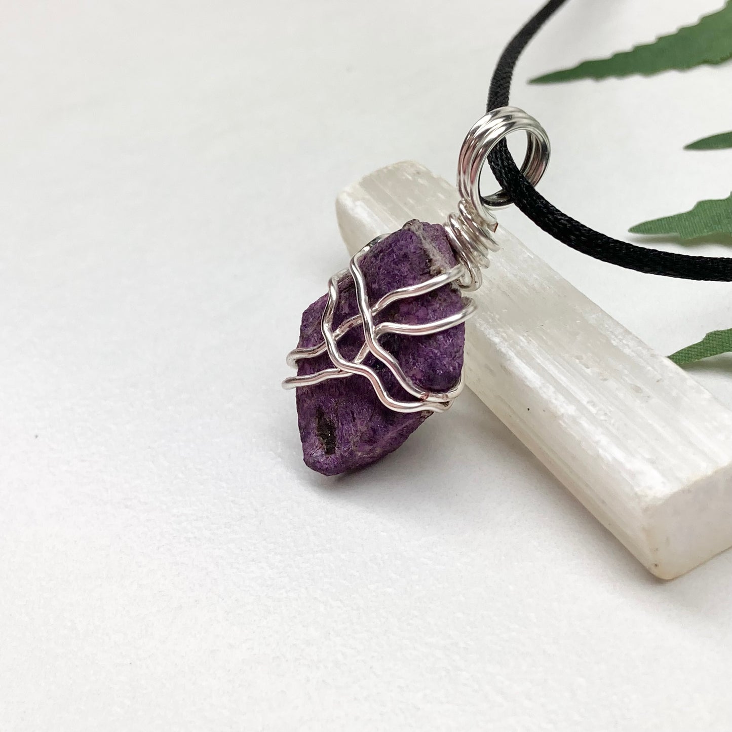 Purpurite necklace. Raw purple Purpurite stone wrapped with silver colored copper wire. Hangs on a black chain. Raw real crystal pendant.
