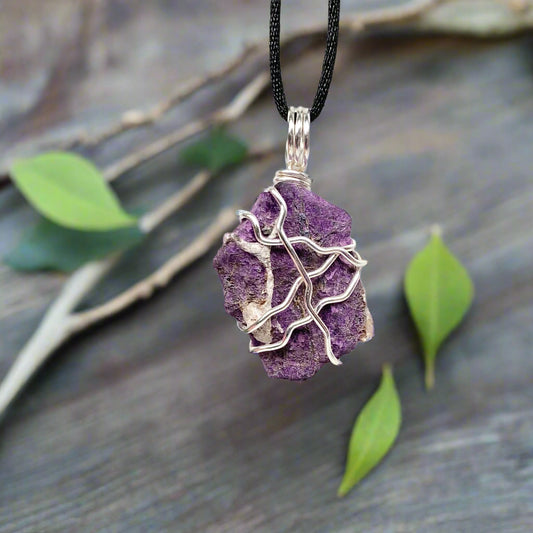 Purpurite necklace. Raw purple Purpurite stone wrapped with silver colored copper wire. Hangs on a black chain. Raw real crystal pendant.