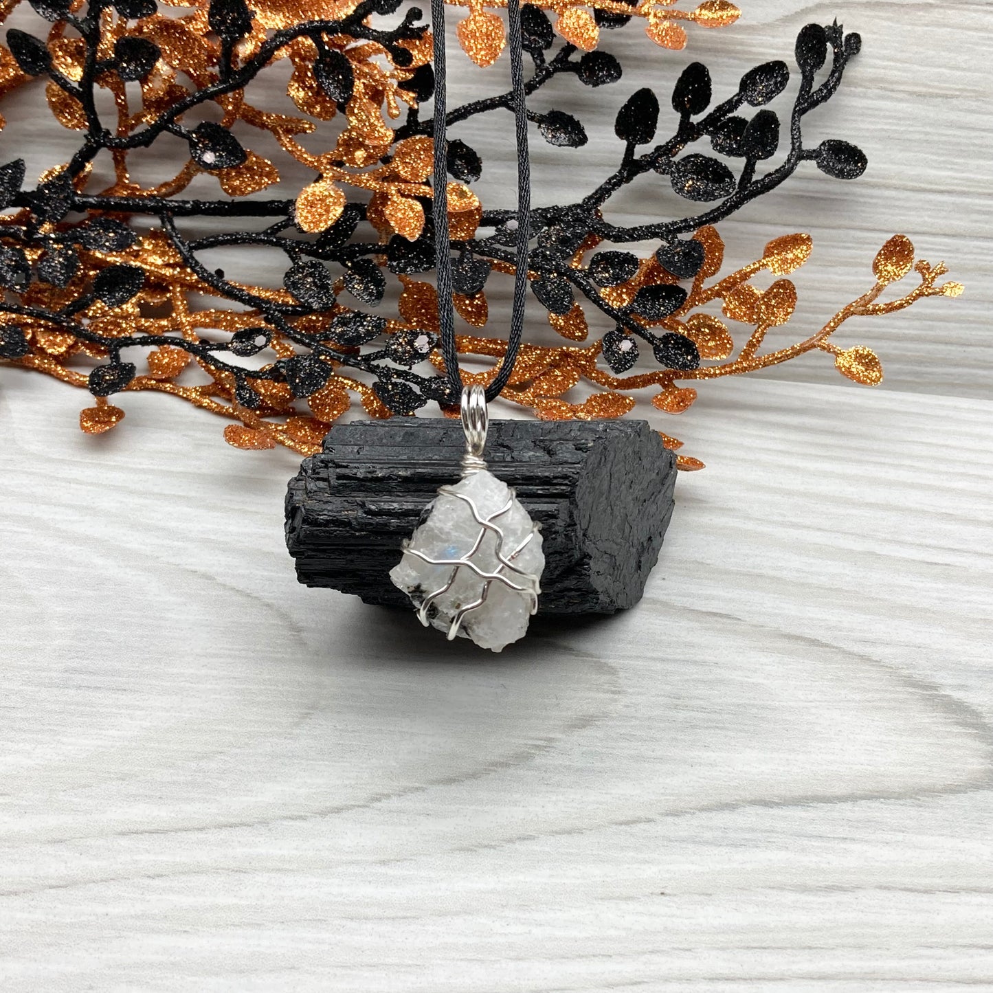 Rainbow Moonstone necklace. Raw Rainbow Moonstone wrapped with silver colored copper wire. Comes on a black chain. White and black crystal wire wrapped pendant. Water element jewelry.