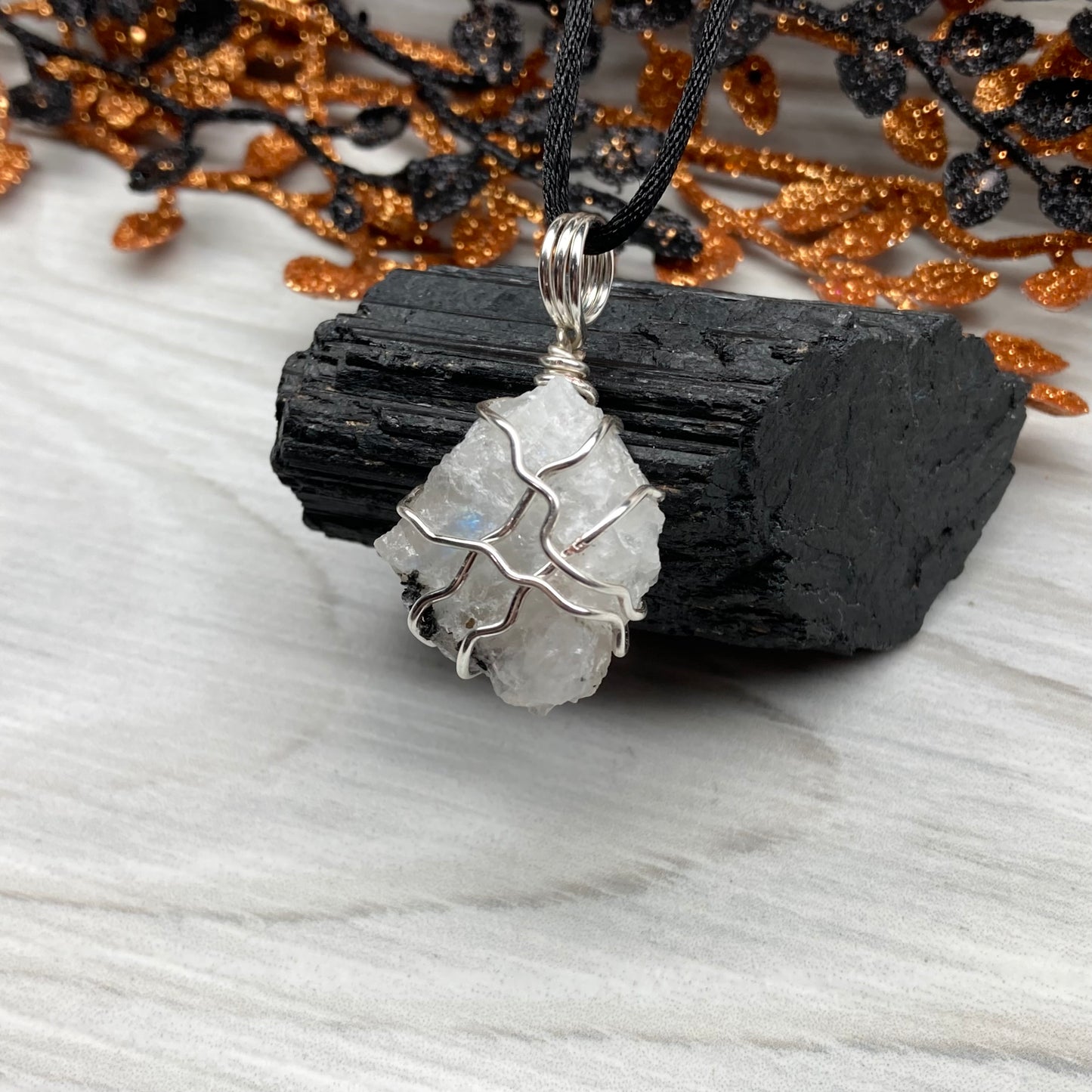 Rainbow Moonstone necklace. Raw Rainbow Moonstone wrapped with silver colored copper wire. Comes on a black chain. White and black crystal wire wrapped pendant. Water element jewelry.