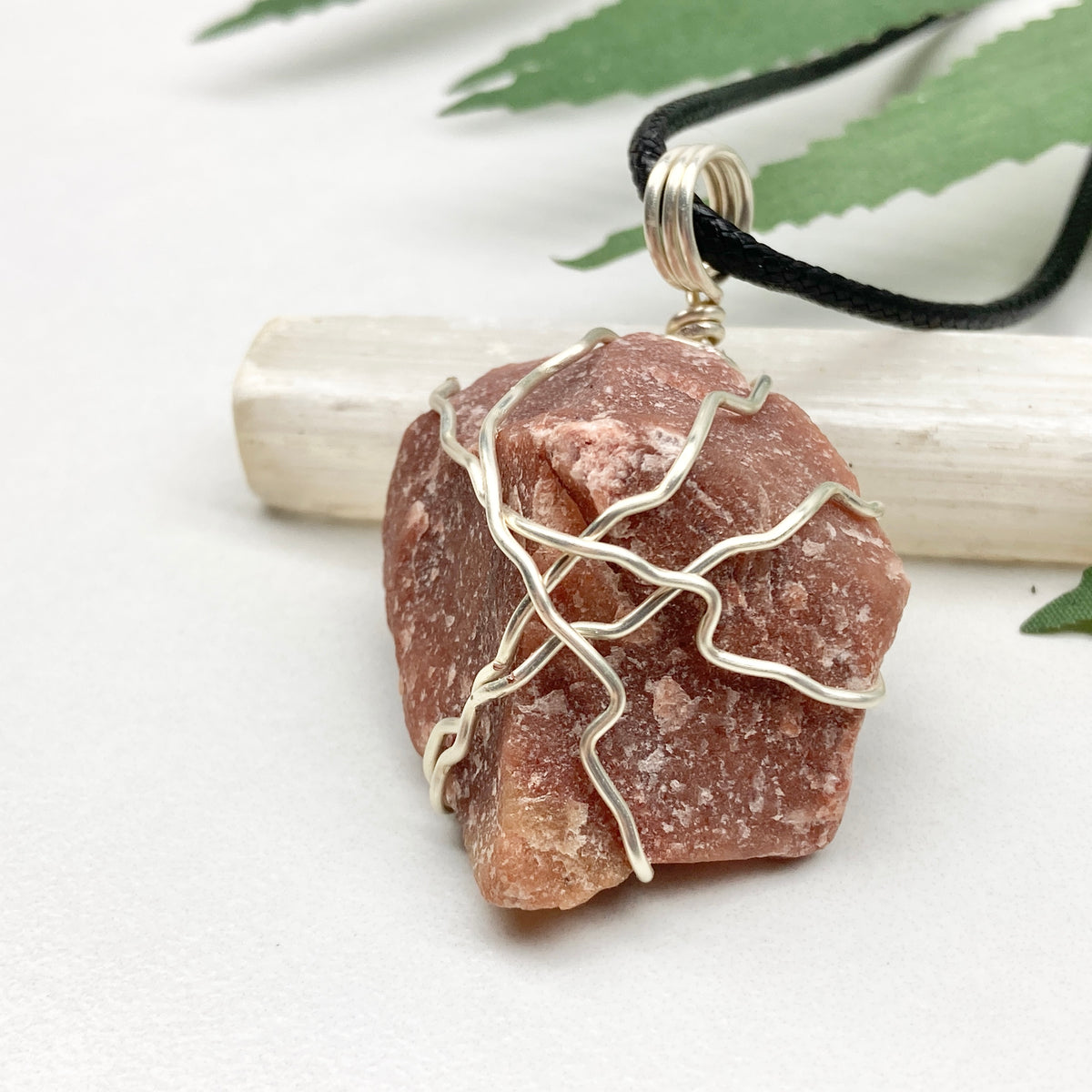 Red Aventurine necklace. Reddish brown stone wrapped with silver copper wire. Hangs on a black chain. Handcrafted spiritual jewelry.