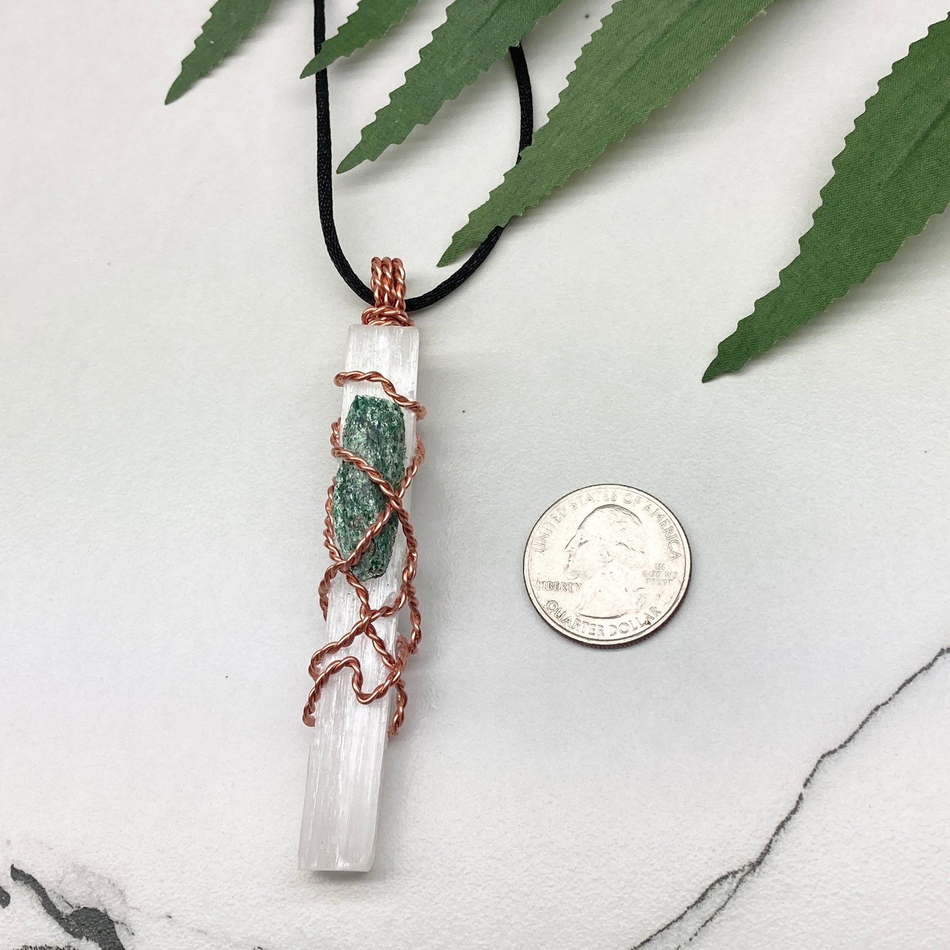 Selenite Fuchsite necklace. A Selenite stick and a raw Fuchsite wrapped together with copper wire. White and green double crystal pendant. Hangs on a black chain. 