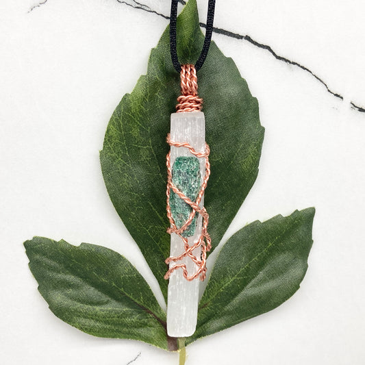 Selenite Fuchsite necklace. A Selenite stick and a raw Fuchsite wrapped together with copper wire. White and green double crystal pendant. Hangs on a black chain. 