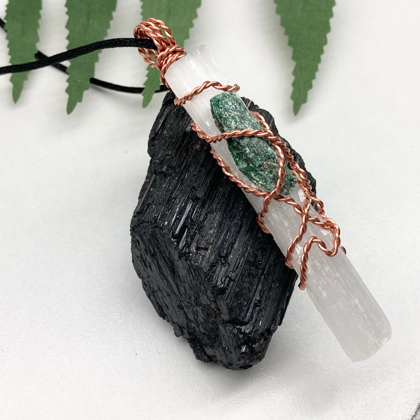 Selenite Fuchsite necklace. A Selenite stick and a raw Fuchsite wrapped together with copper wire. White and green double crystal pendant. Hangs on a black chain. 