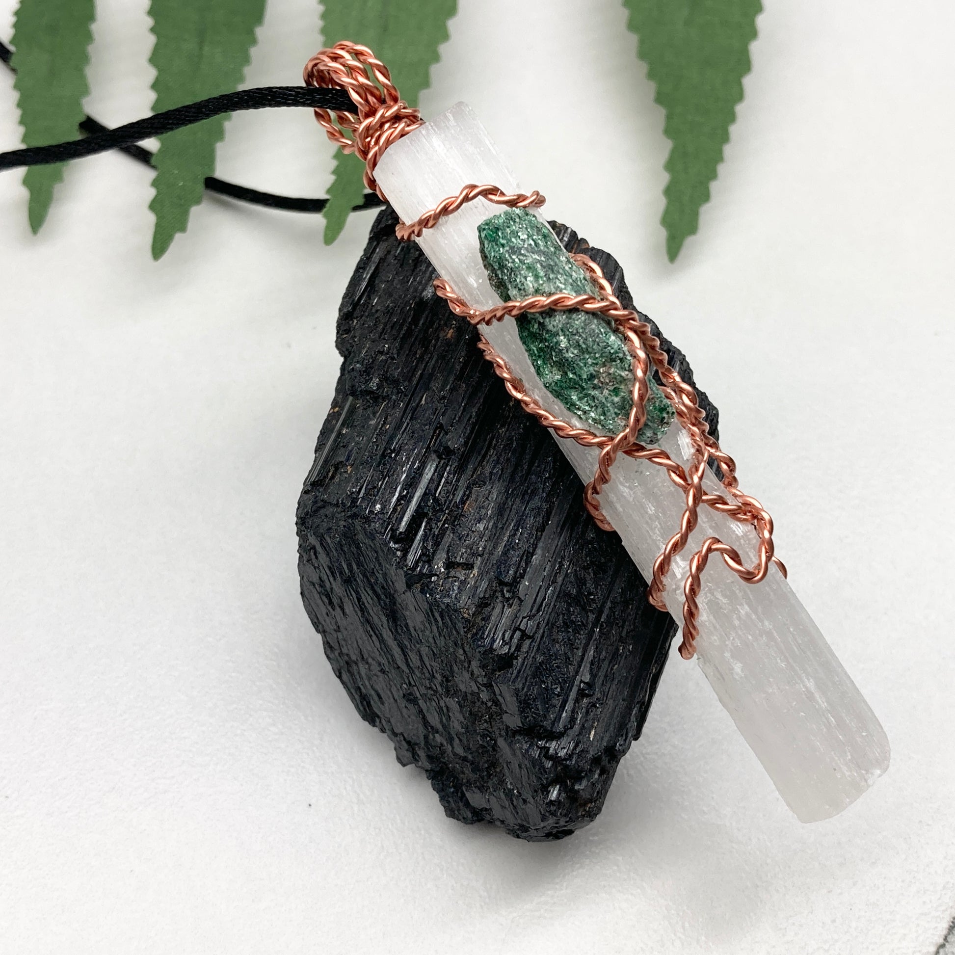 Selenite Fuchsite necklace. A Selenite stick and a raw Fuchsite wrapped together with copper wire. White and green double crystal pendant. Hangs on a black chain. 