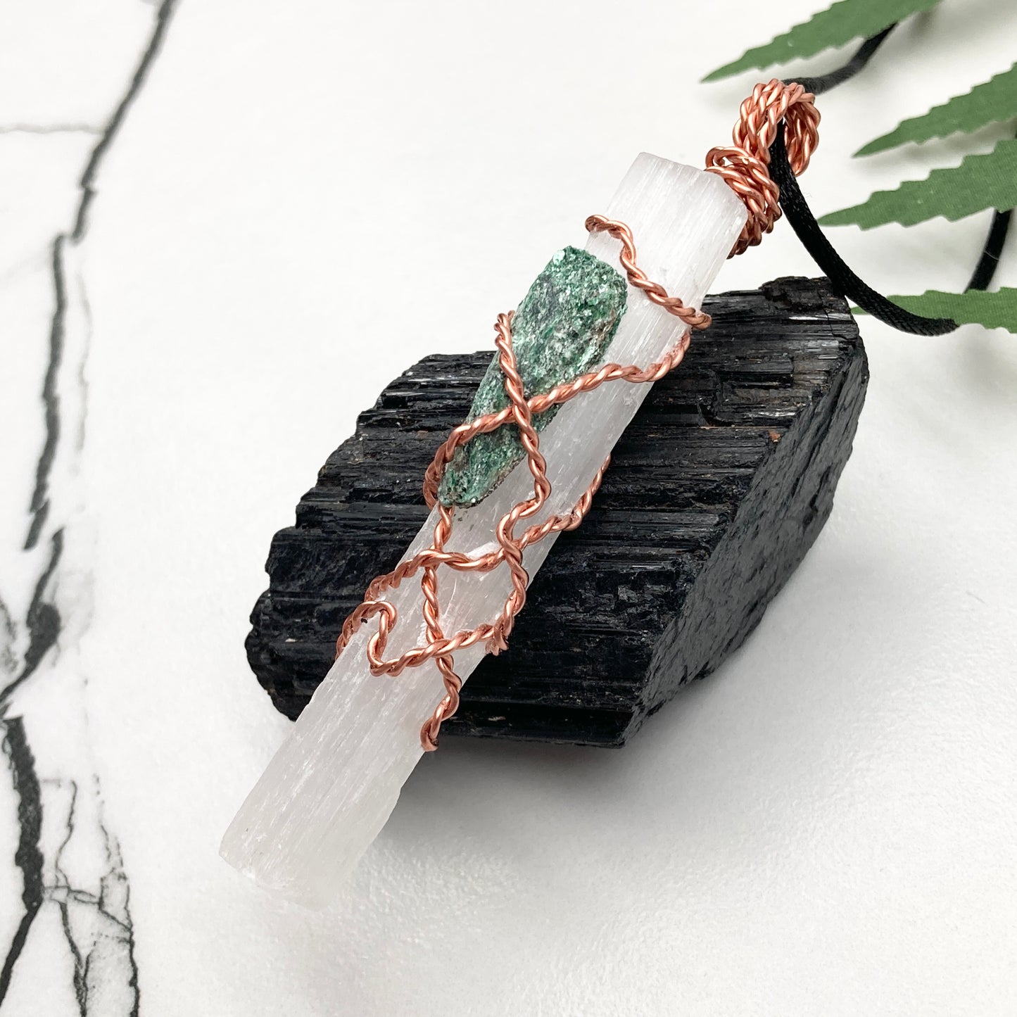 Selenite Fuchsite necklace. A Selenite stick and a raw Fuchsite wrapped together with copper wire. White and green double crystal pendant. Hangs on a black chain. 