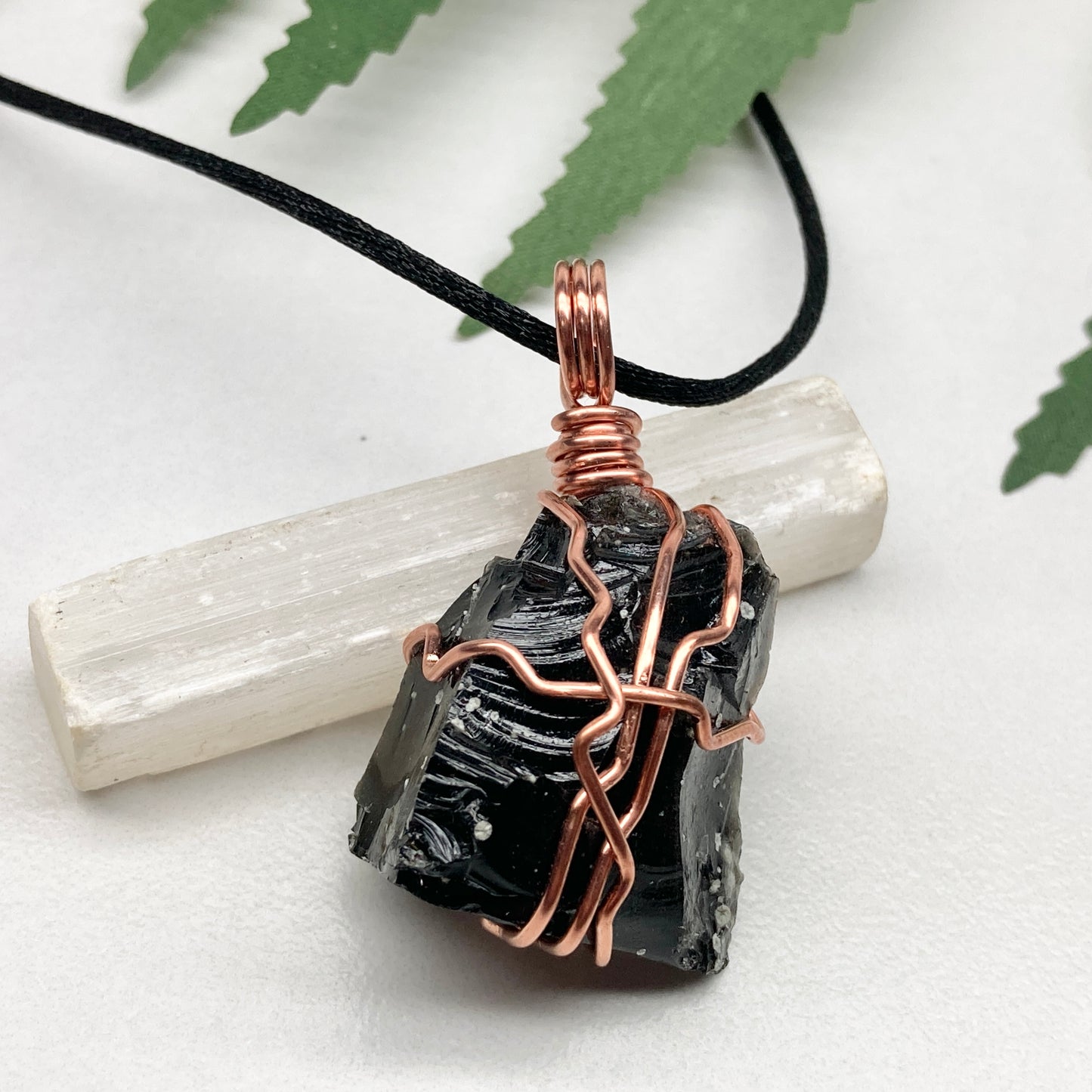 Snowflake Obsidian necklace. Black stone with gray spots wrapped with pure copper wire. Hangs on a black chain. Spiritual handmade jewelry.