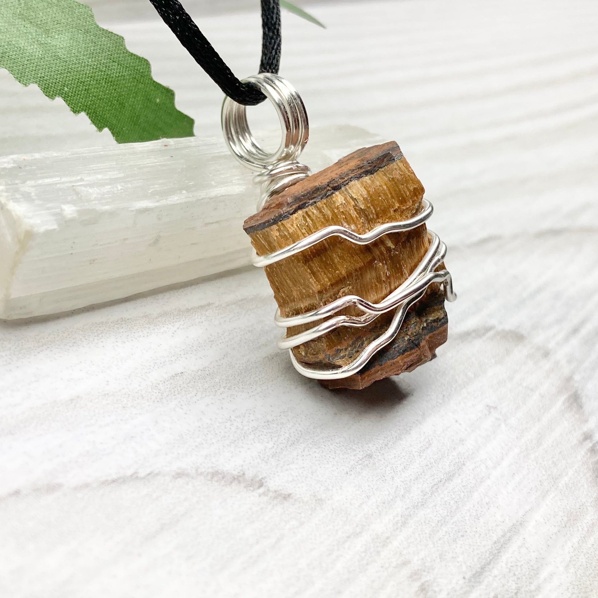 Tigers Eye necklace. Raw Tiger Eye stone wrapped with tarnish resistant silver copper wire. This stone is gold and brown. Unisex handmade pendant. Comes on a black chain with silver ends. Leo zodiac gift. 