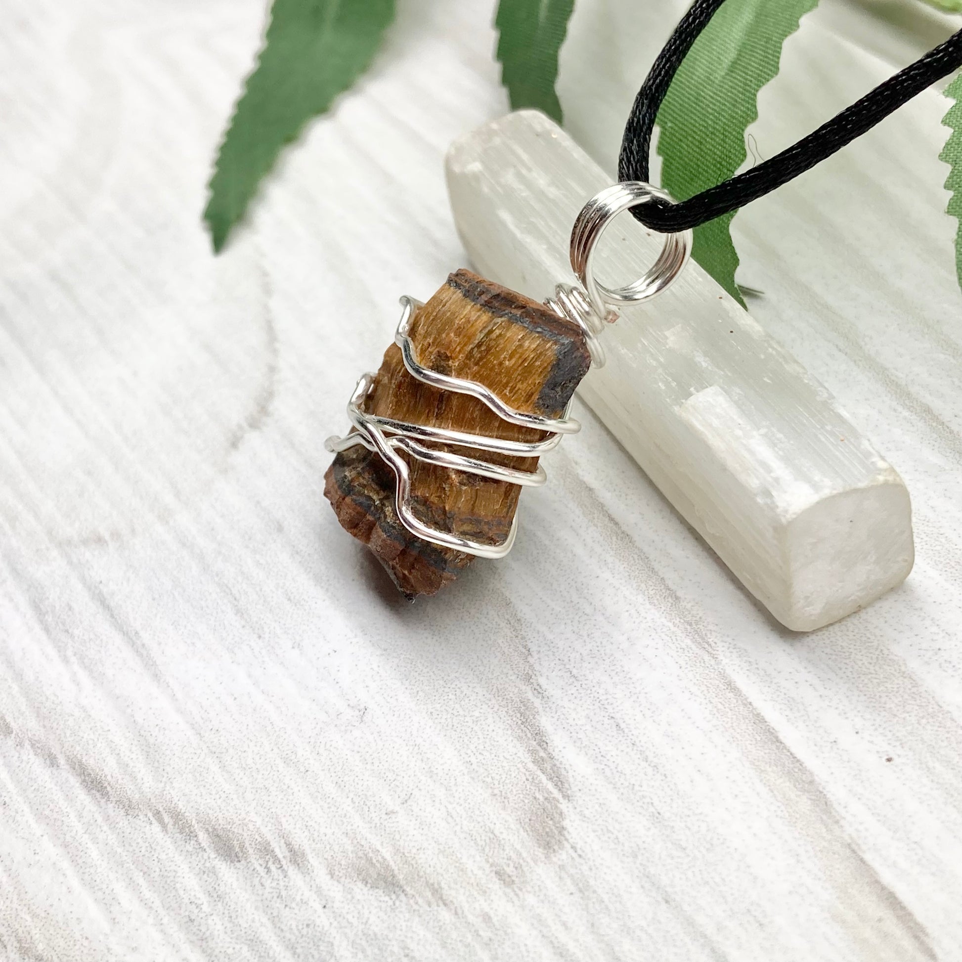 Tigers Eye necklace. Raw Tiger Eye stone wrapped with tarnish resistant silver copper wire. This stone is gold and brown. Unisex handmade pendant. Comes on a black chain with silver ends. Leo zodiac gift. 