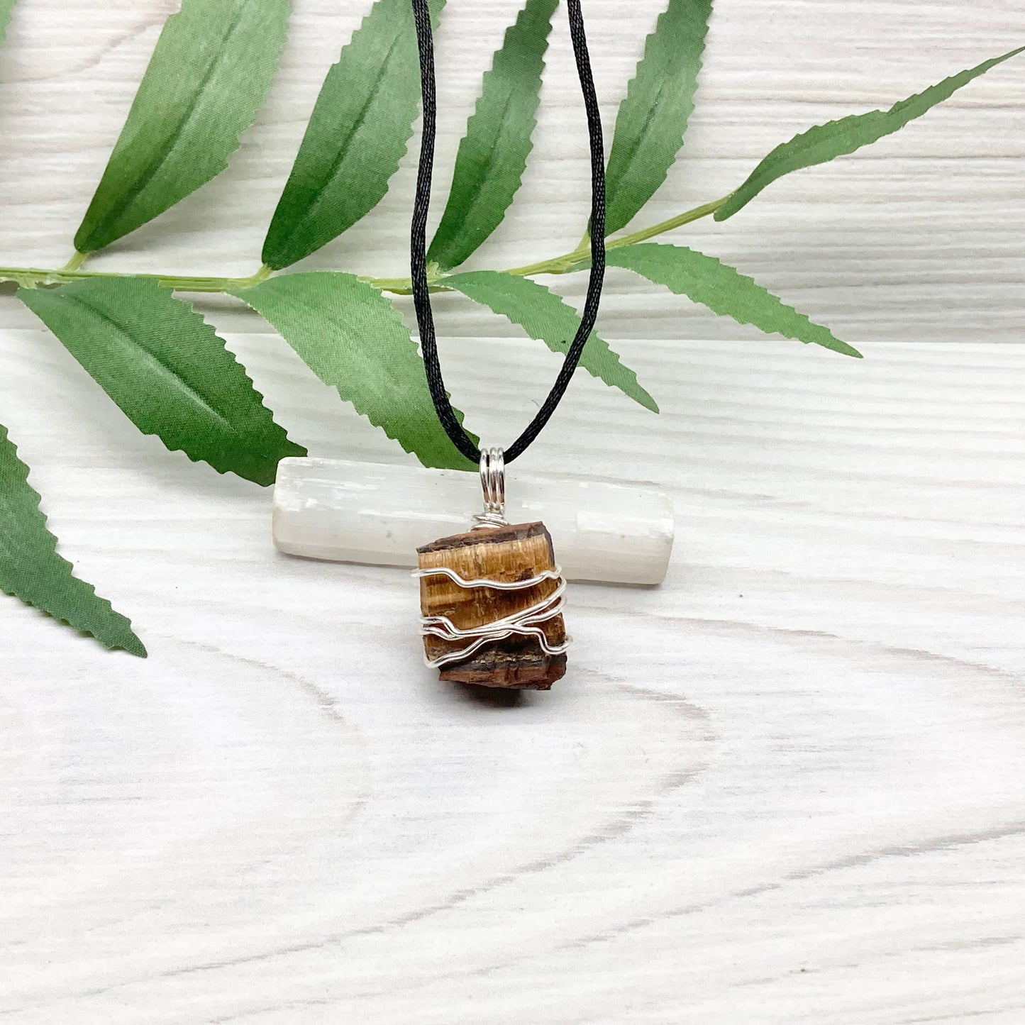 Tigers Eye necklace. Raw Tiger Eye stone wrapped with tarnish resistant silver copper wire. This stone is gold and brown. Unisex handmade pendant. Comes on a black chain with silver ends. Leo zodiac gift. 