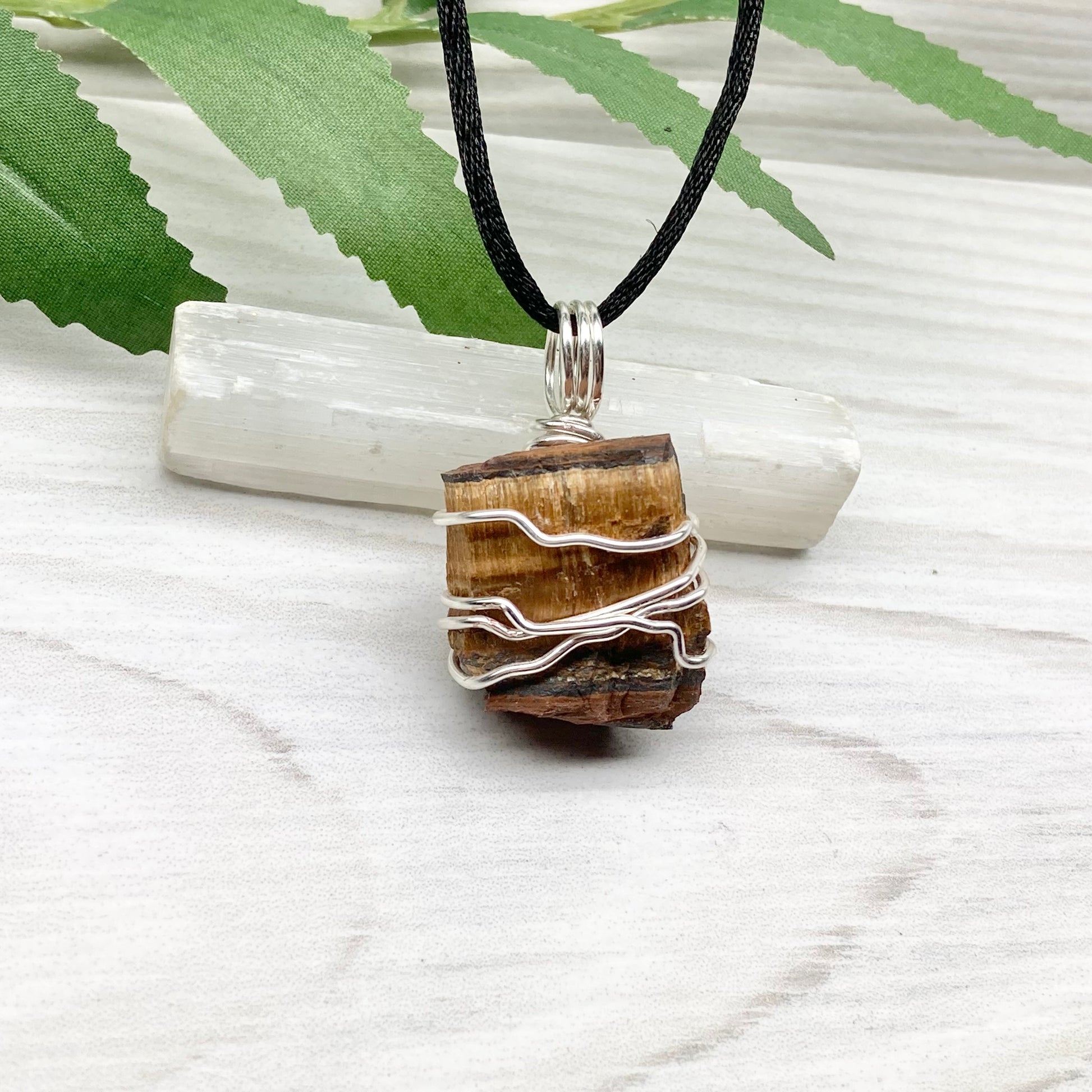 Tigers Eye necklace. Raw Tiger Eye stone wrapped with tarnish resistant silver copper wire. This stone is gold and brown. Unisex handmade pendant. Comes on a black chain with silver ends. Leo zodiac gift. 