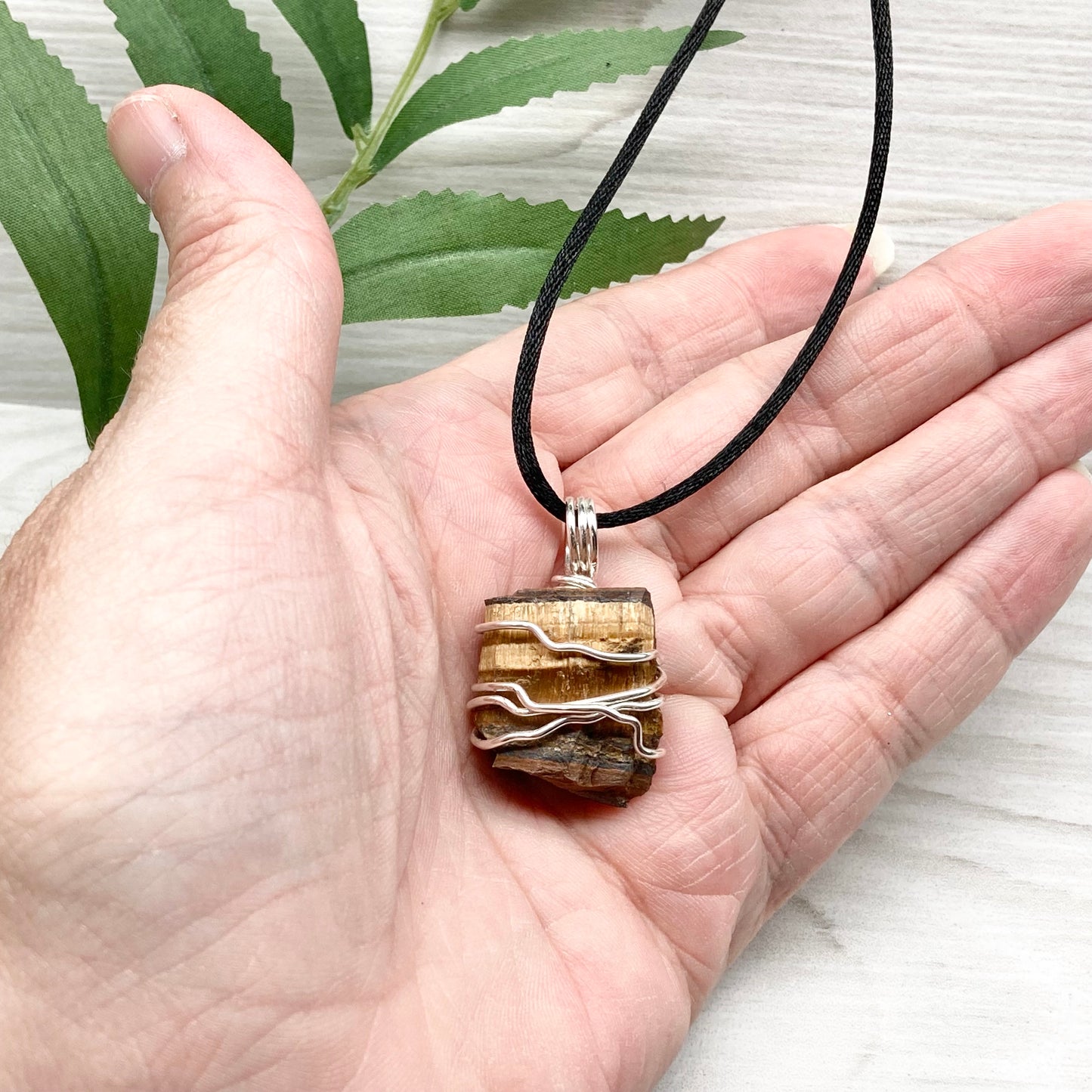 Tigers Eye necklace. Raw Tiger Eye stone wrapped with tarnish resistant silver copper wire. This stone is gold and brown. Unisex handmade pendant. Comes on a black chain with silver ends. Leo zodiac gift. 