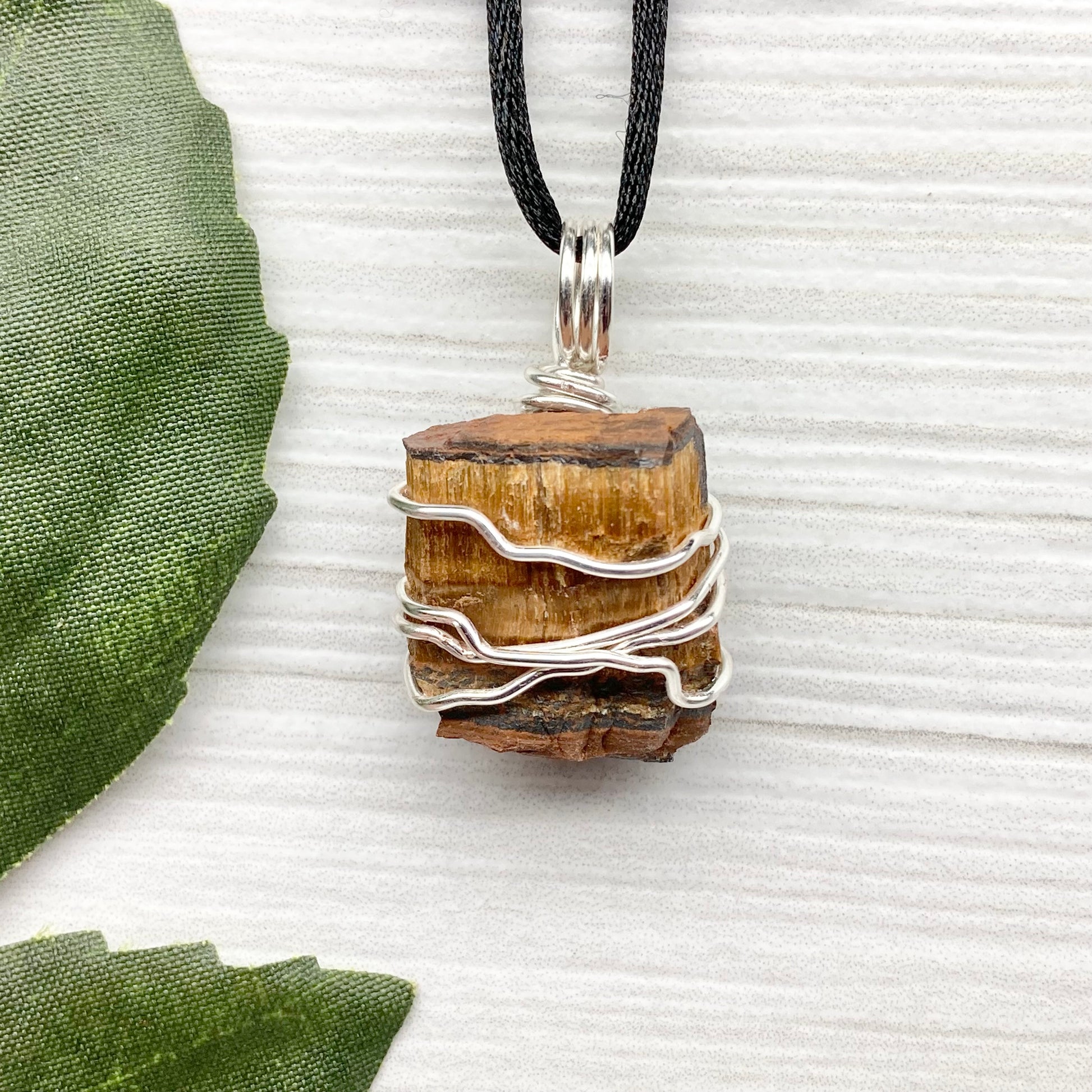 Tigers Eye necklace. Raw Tiger Eye stone wrapped with tarnish resistant silver copper wire. This stone is gold and brown. Unisex handmade pendant. Comes on a black chain with silver ends. Leo zodiac gift. 