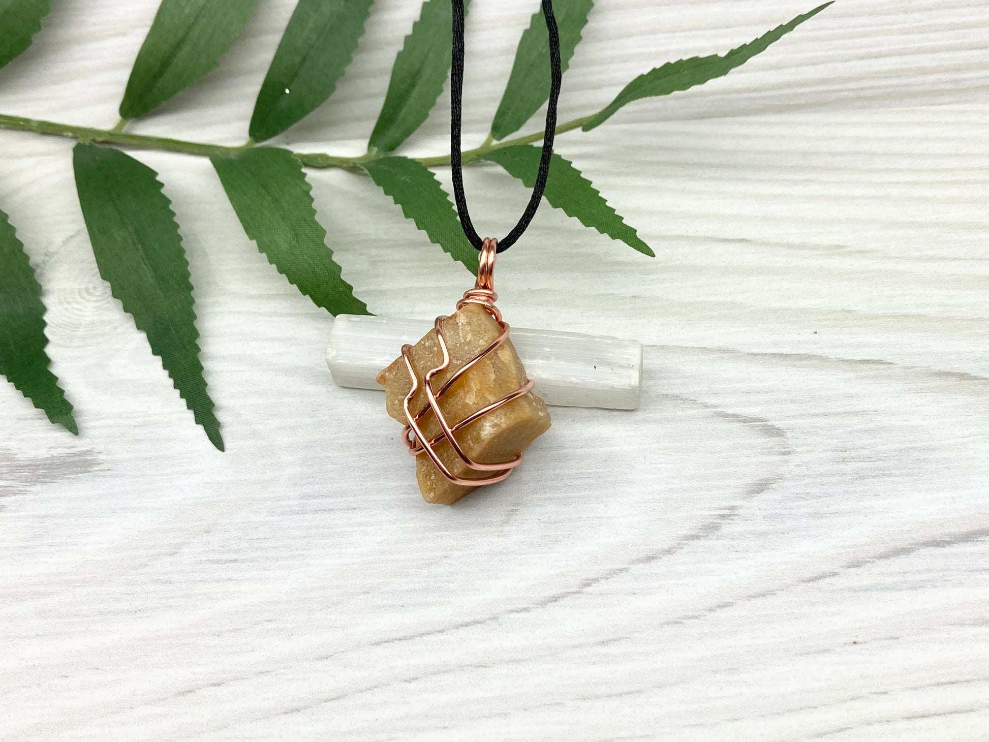 Yellow aventurine necklace. Yellow raw stone wrapped with copper wire. Comes on a black necklace. Handcrafted new age jewelry.