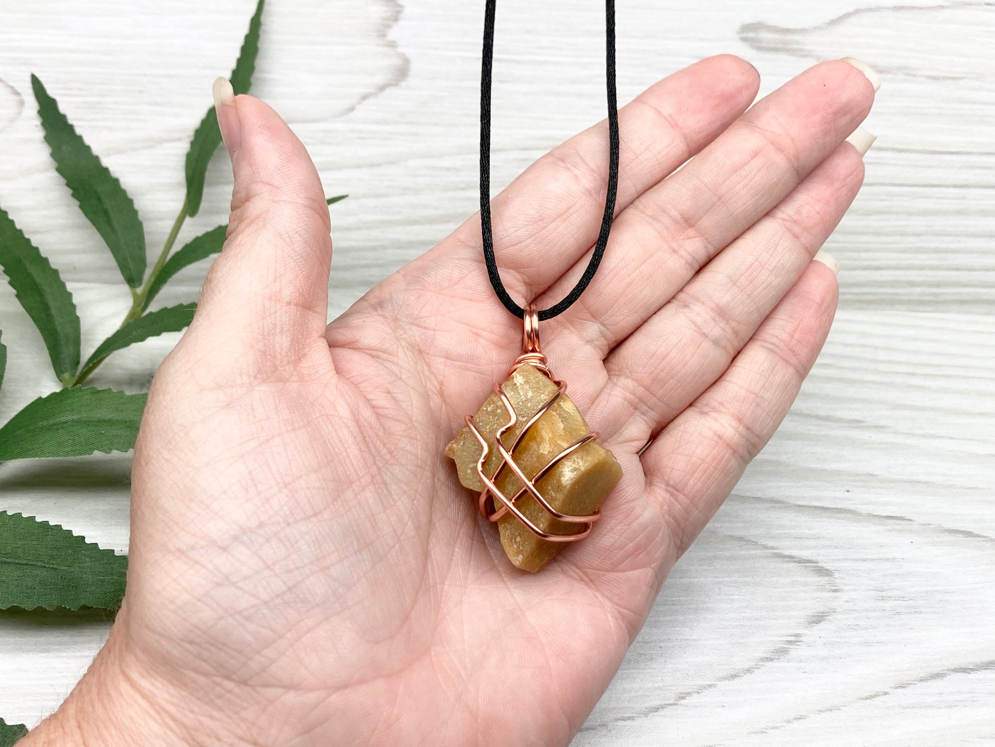 Yellow aventurine necklace. Yellow raw stone wrapped with copper wire. Comes on a black necklace. Handcrafted new age jewelry.