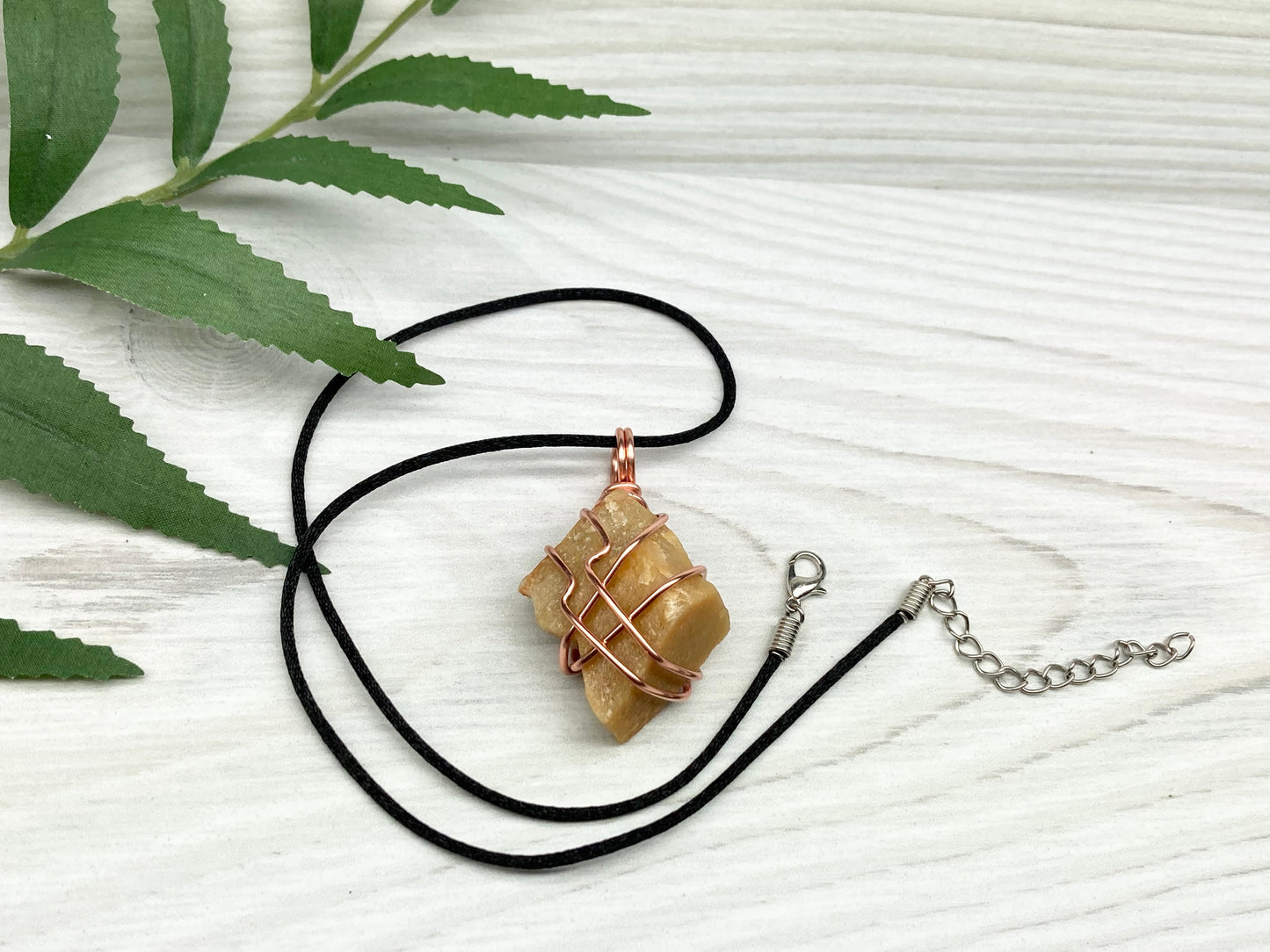 Yellow aventurine necklace. Yellow raw stone wrapped with copper wire. Comes on a black necklace. Handcrafted new age jewelry.