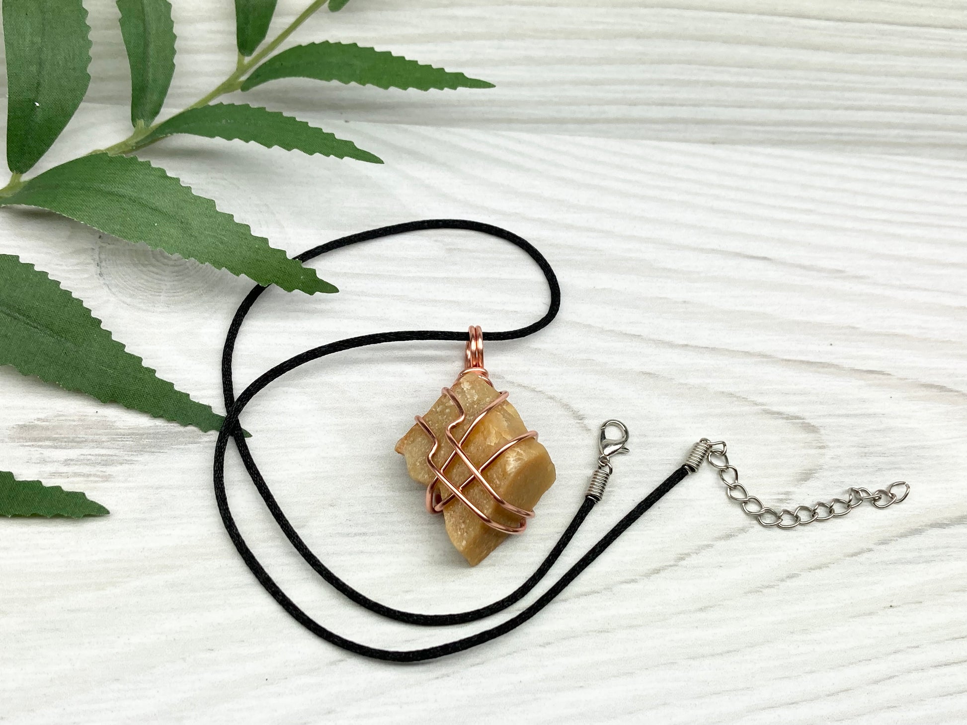 Yellow aventurine necklace. Yellow raw stone wrapped with copper wire. Comes on a black necklace. Handcrafted new age jewelry.