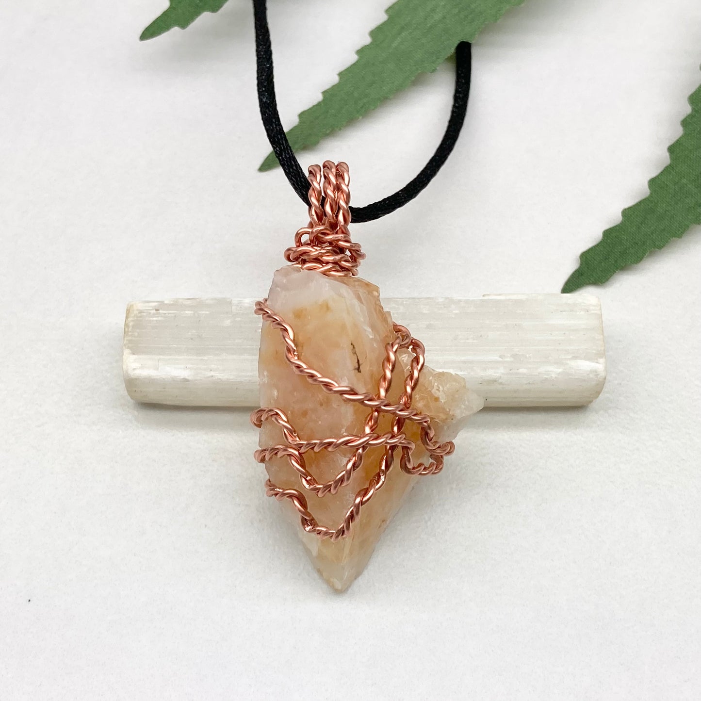 Yellow Opal necklace. Raw yellow stone wrapped with pure copper wire. Hangs on a black chain.