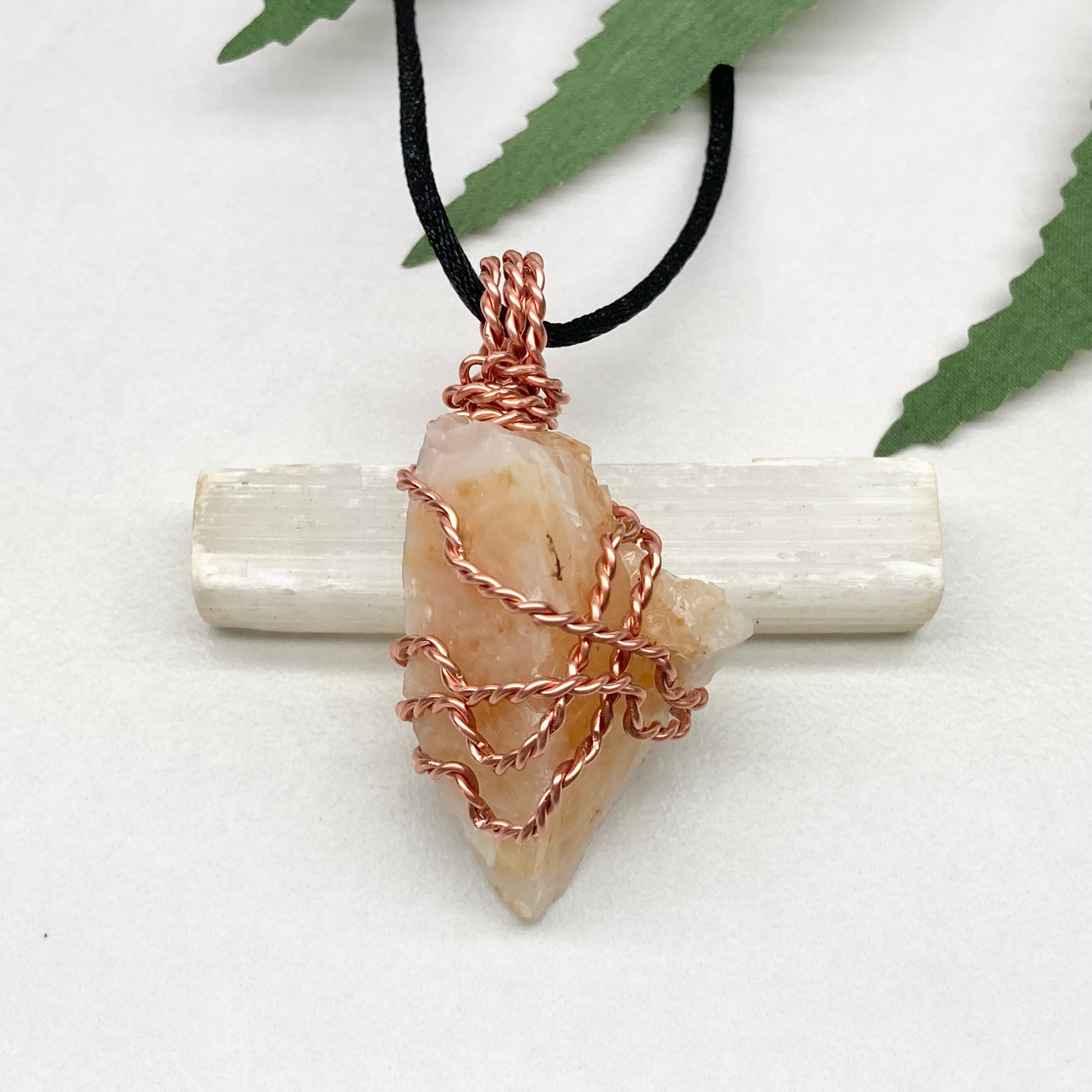 Yellow Opal necklace. Raw yellow stone wrapped with pure copper wire. Hangs on a black chain.