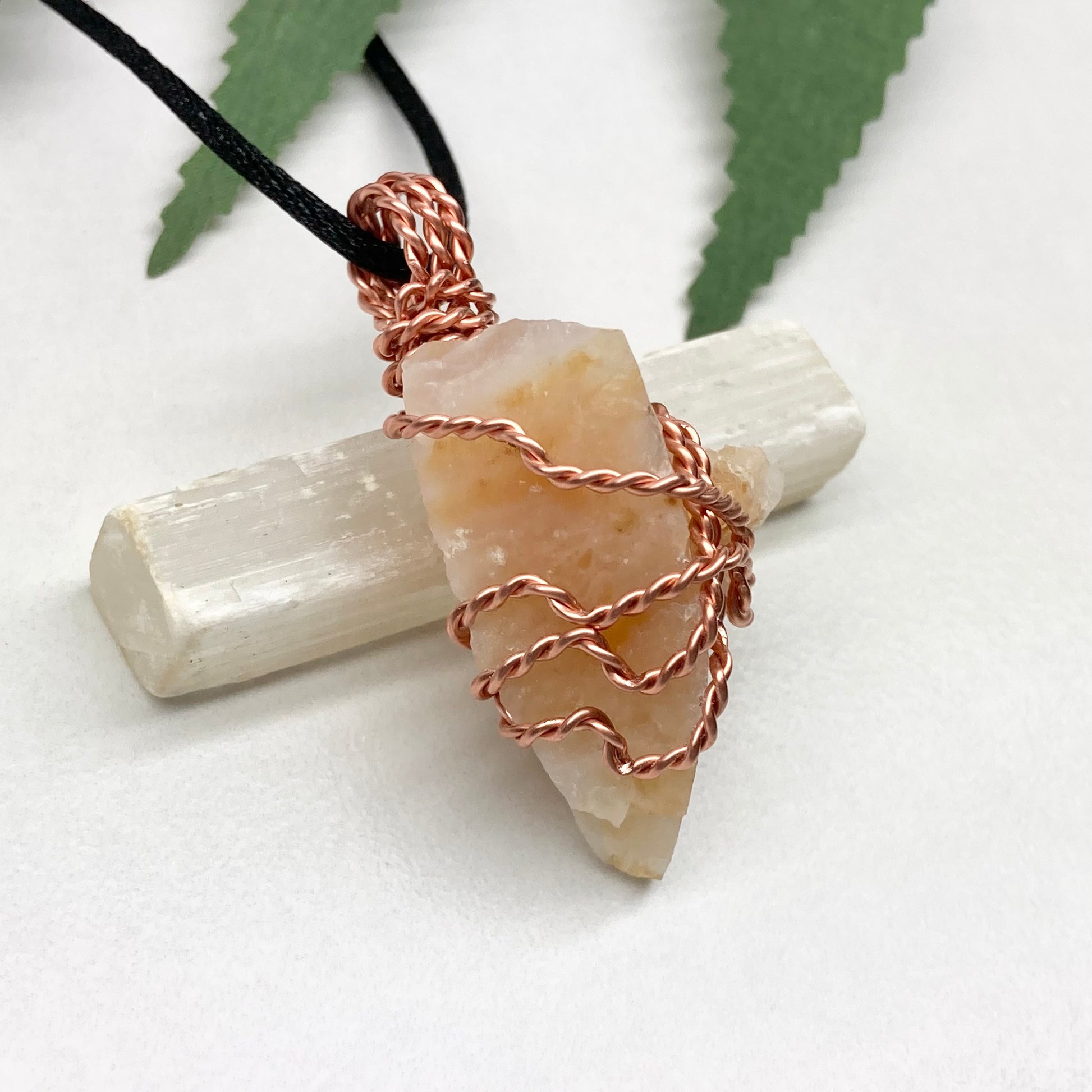 Yellow Opal necklace. Raw yellow stone wrapped with pure copper wire. Hangs on a black chain.