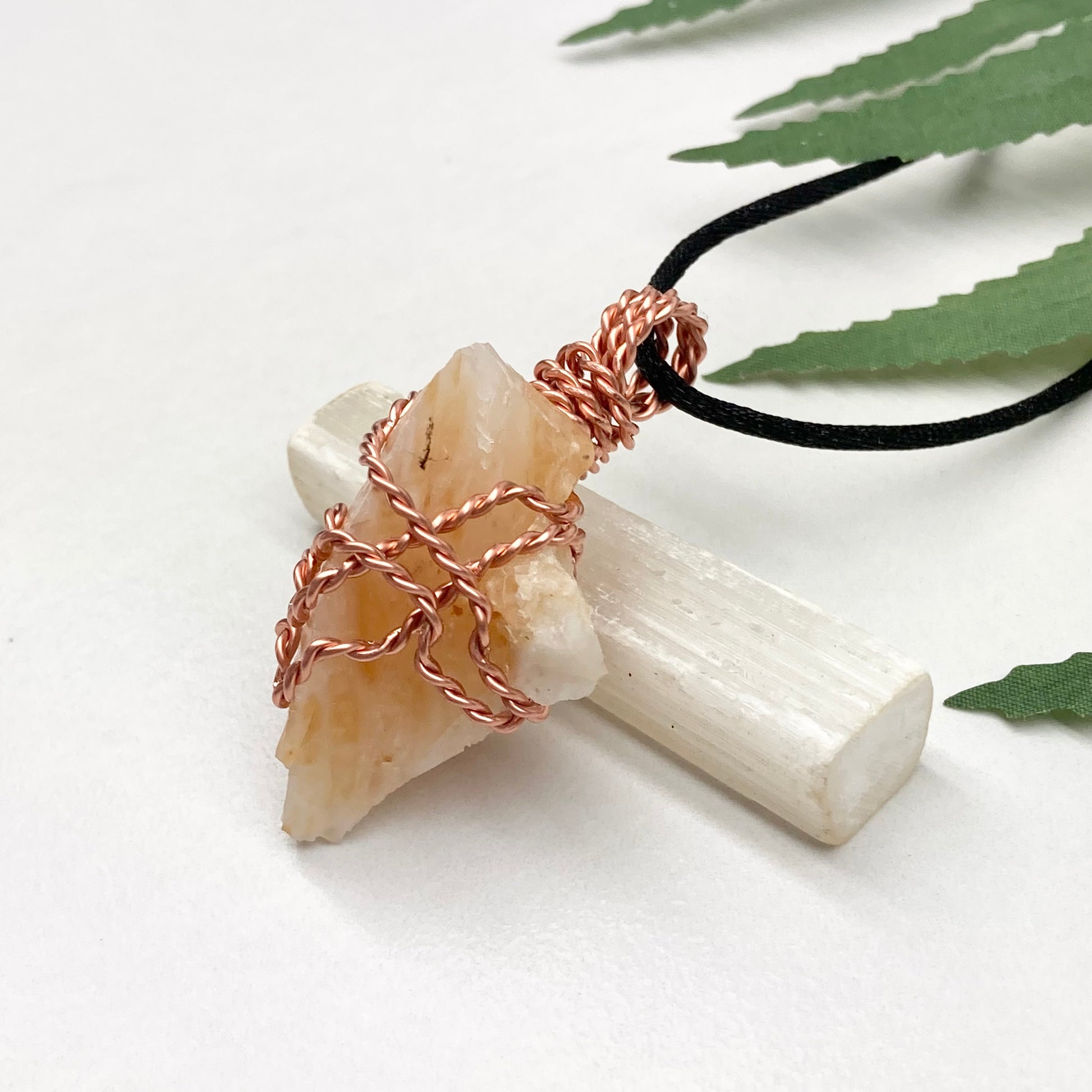 Yellow Opal necklace. Raw yellow stone wrapped with pure copper wire. Hangs on a black chain.