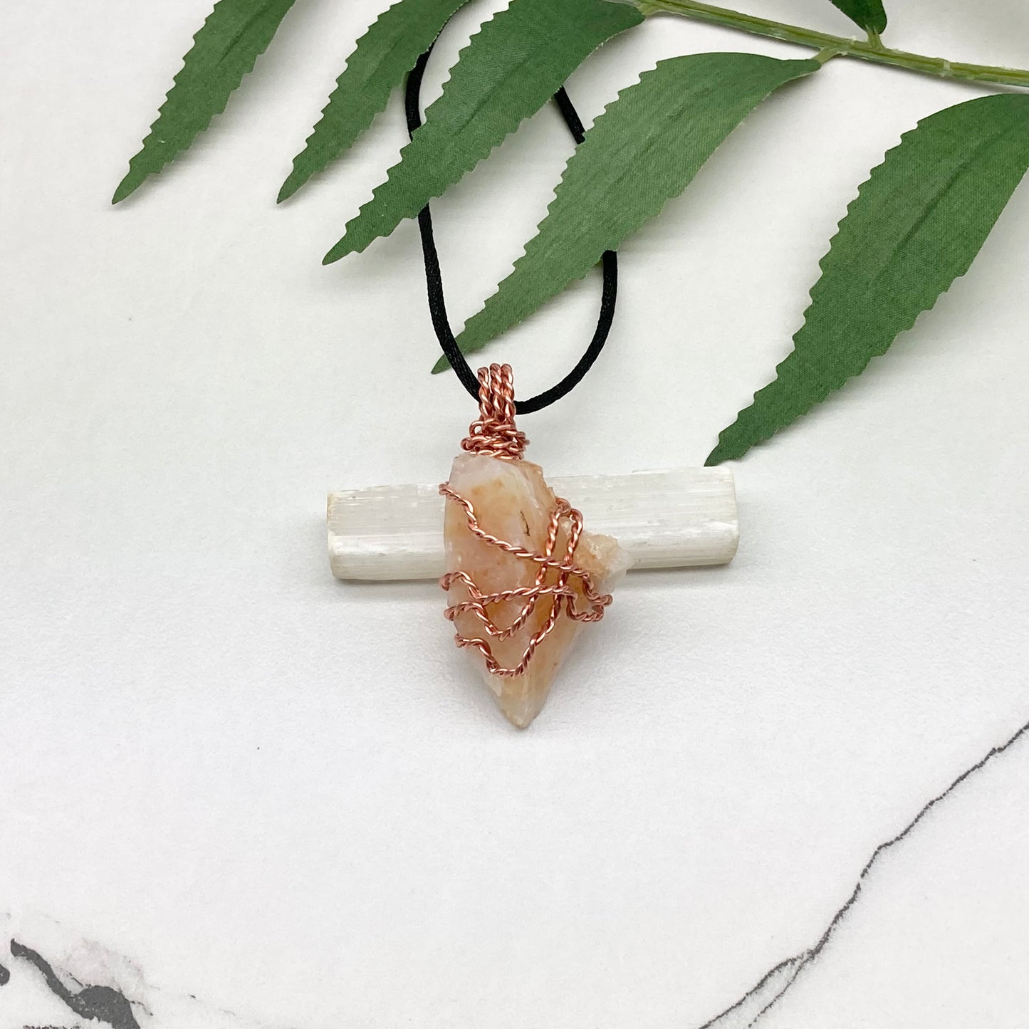 Yellow Opal necklace. Raw yellow stone wrapped with pure copper wire. Hangs on a black chain.