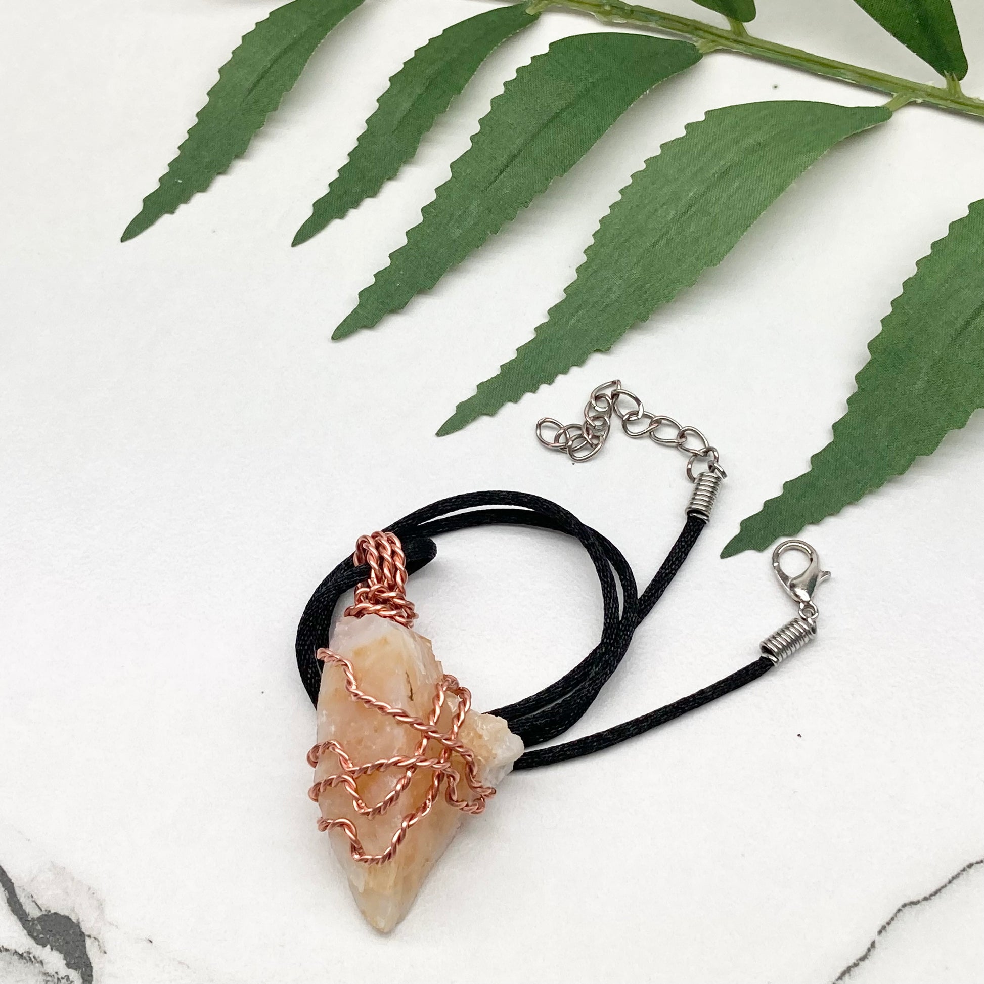 Yellow Opal necklace. Raw yellow stone wrapped with pure copper wire. Hangs on a black chain.