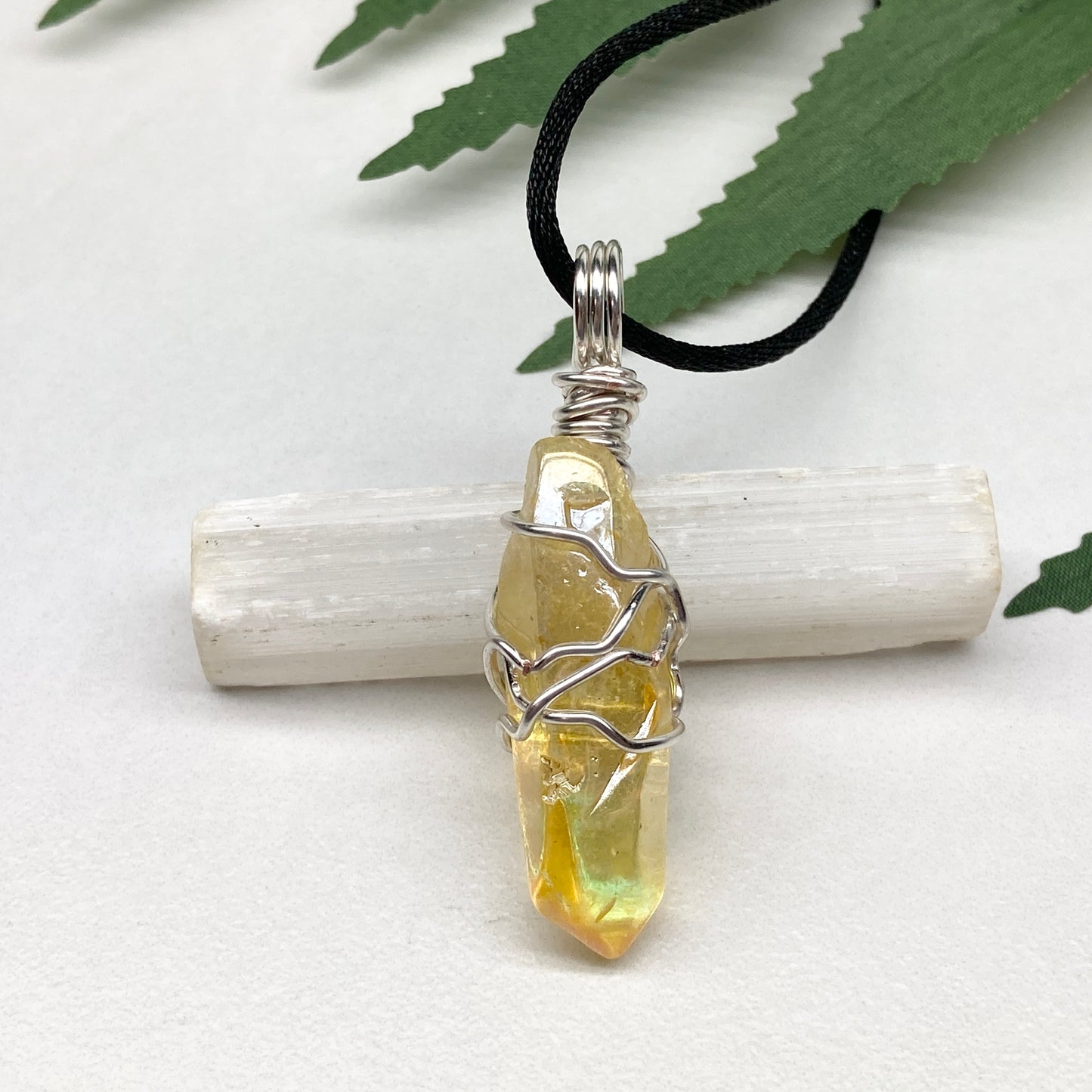 Yellow Aura Quartz necklace. Yellow crystal wrapped with silver colored copper wire. Hangs on a black chain. Handmade yellow stone pendant.