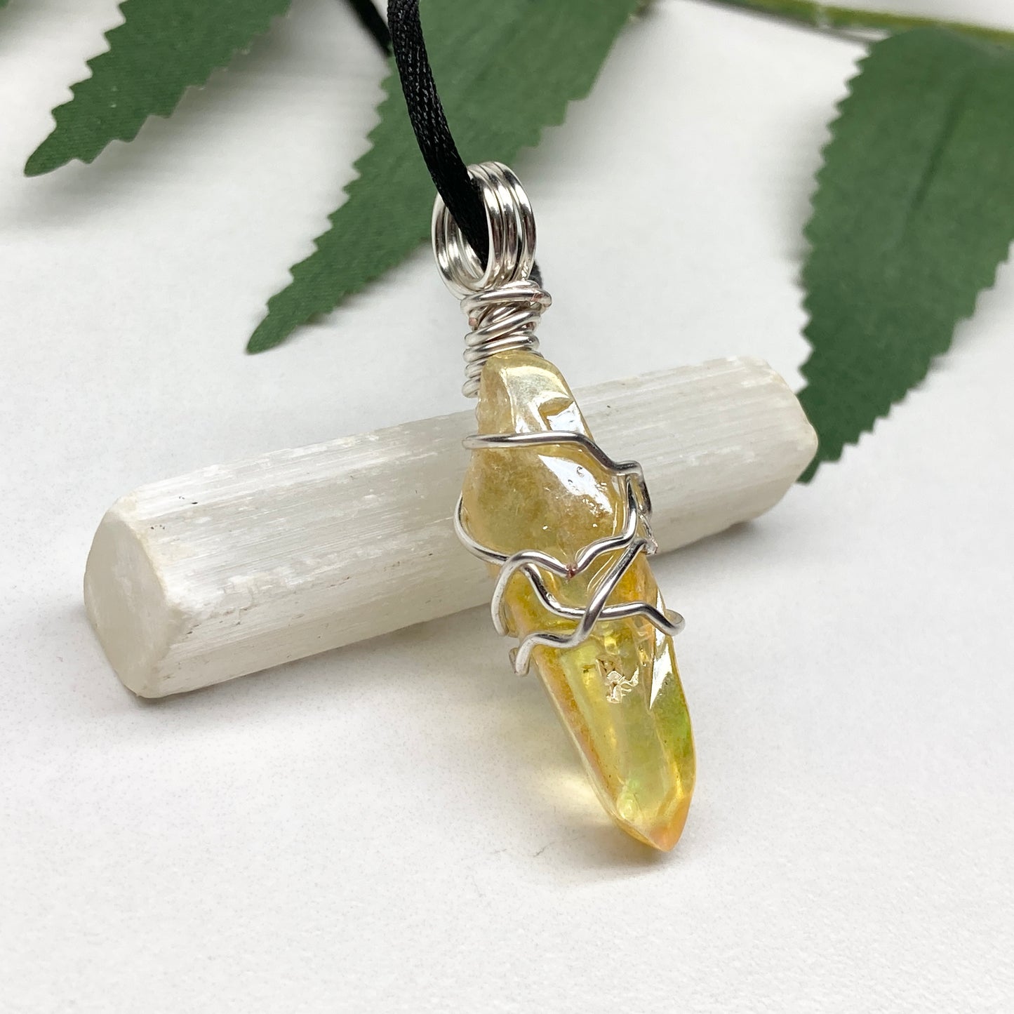 Yellow Aura Quartz necklace. Yellow crystal wrapped with silver colored copper wire. Hangs on a black chain. Handmade yellow stone pendant.