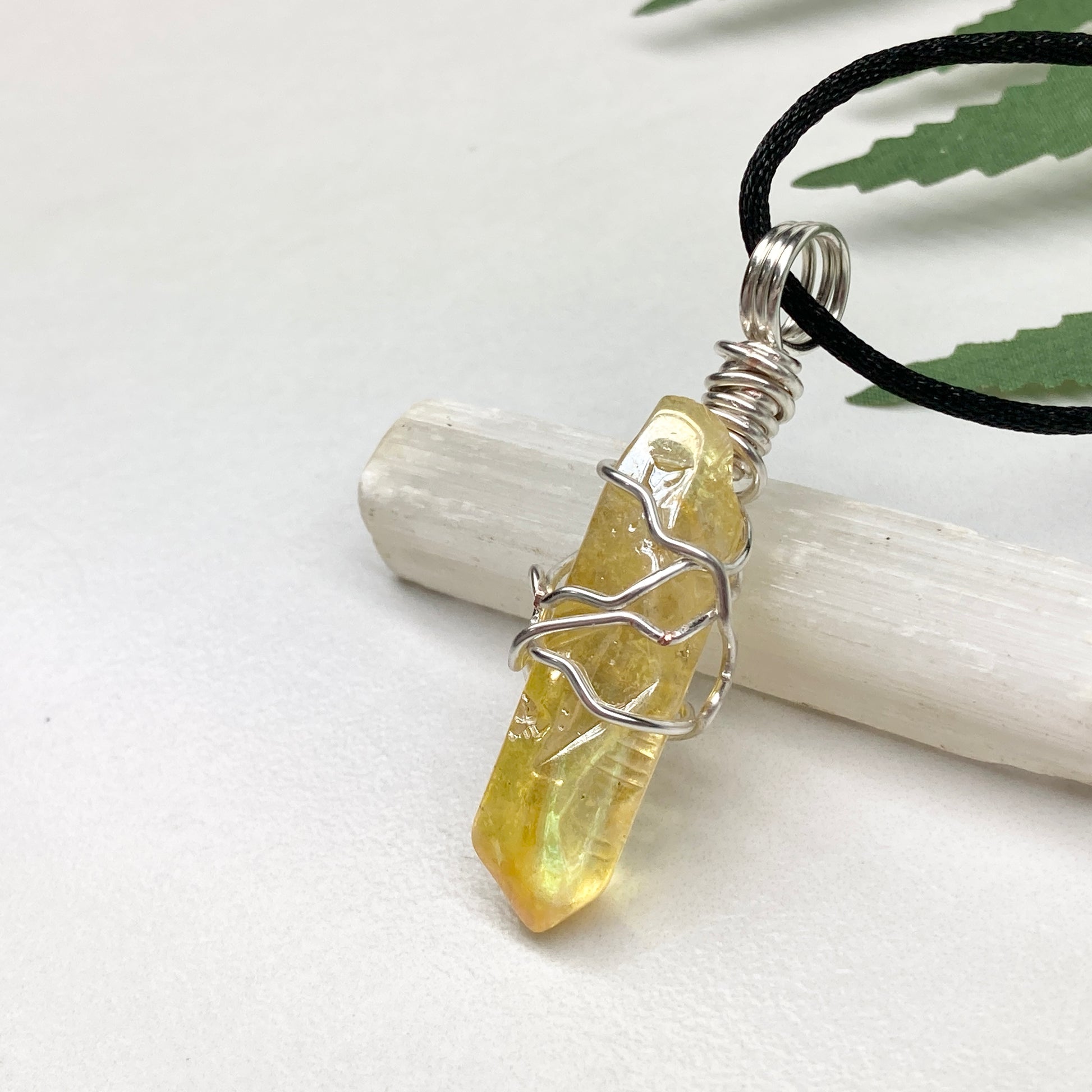 Yellow Aura Quartz necklace. Yellow crystal wrapped with silver colored copper wire. Hangs on a black chain. Handmade yellow stone pendant.